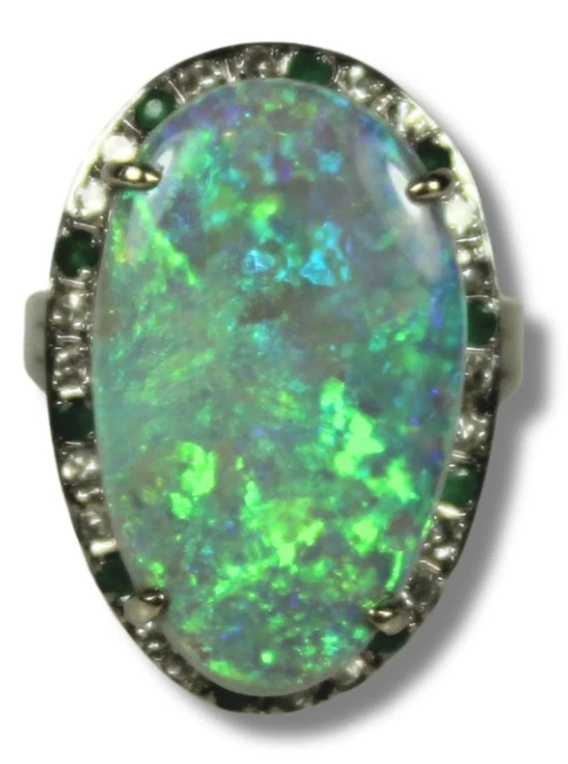 SOLID SEMI-BLACK OPAL SURROUNDED BY A HALO OF DIAMONDS & EMERALDS IN 14CT YELLOW GOLD RING SETTING: Solid Semi-Black Opal surrounded by a Halo of Diamonds & Emeralds in 14ct Yellow Gold Ring setting
