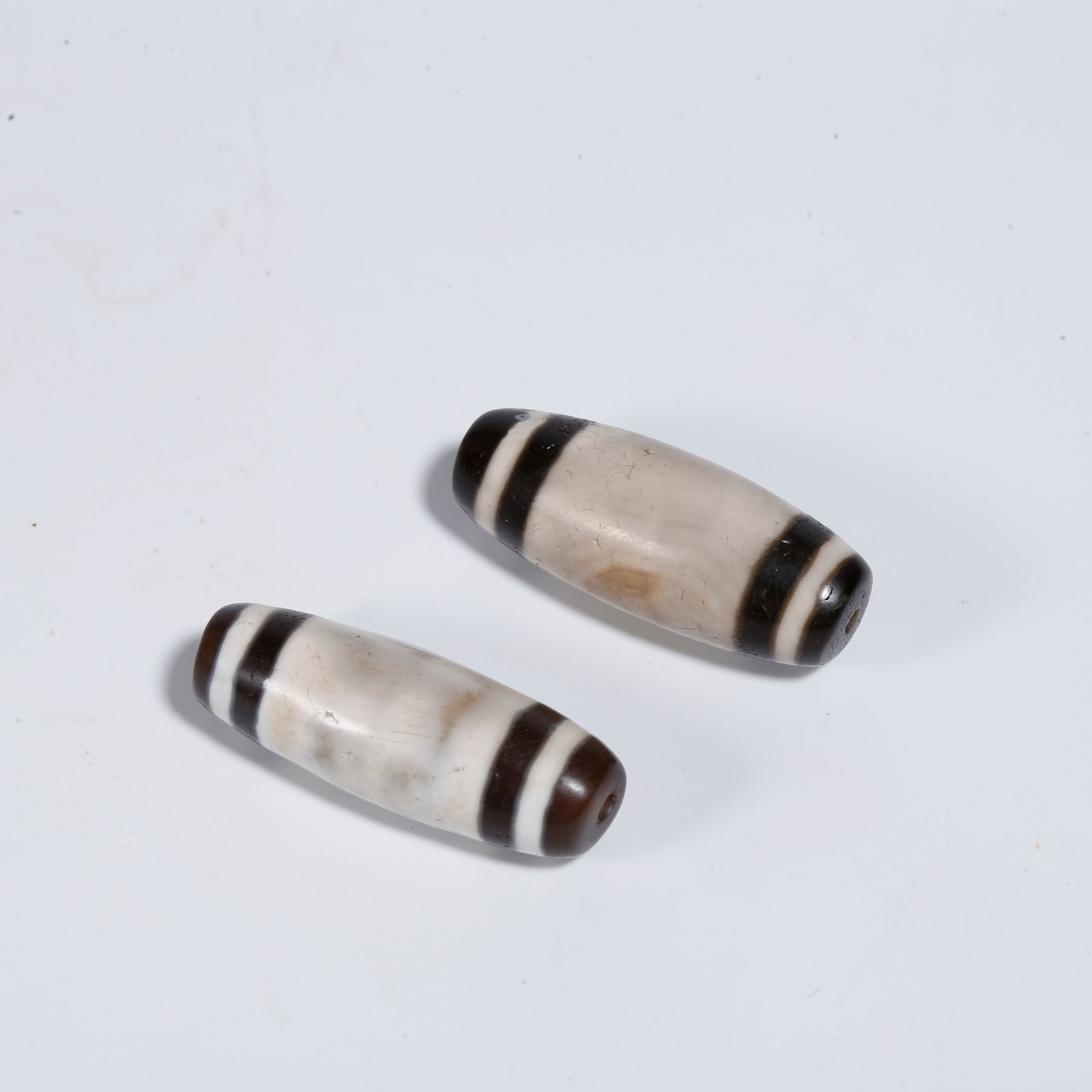 A PAIR OF AGATE DZI BEADS: Pair of Agate Dzi Beads