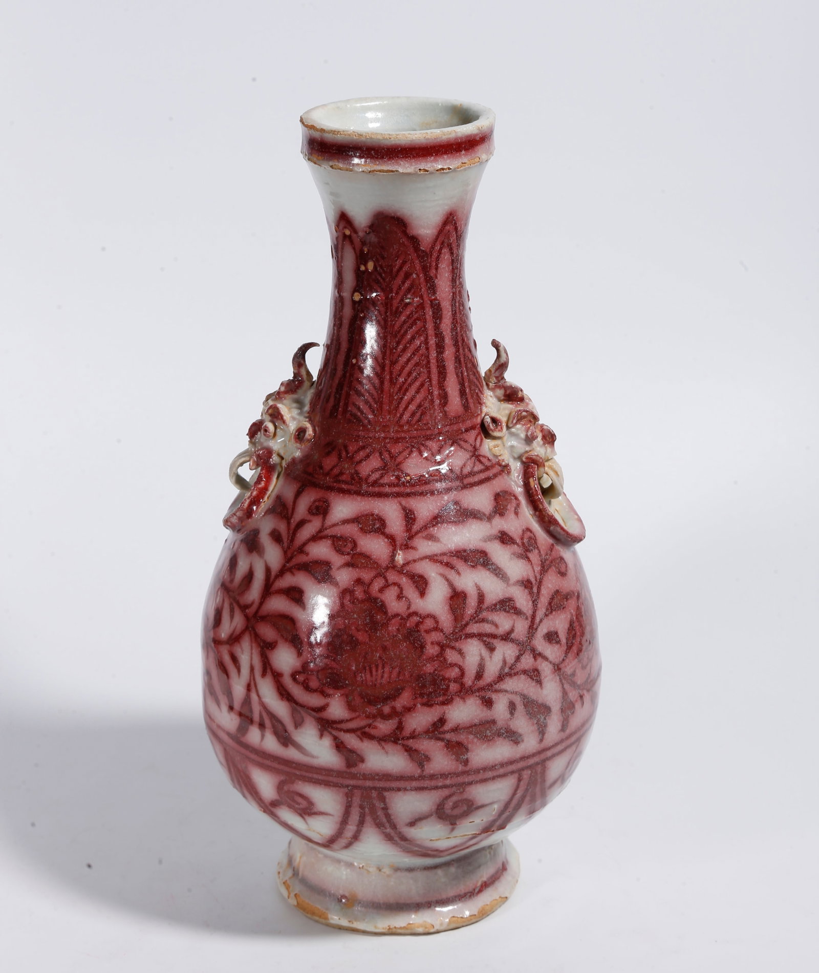 A UNDERGLAZE RED VASE WITH DOUBLE BEAST HANDLES AND INTERLOCKING FLORAL SCROLLS: Underglaze Red Vase with Double Beast Handles and Interlocking Floral Scrolls