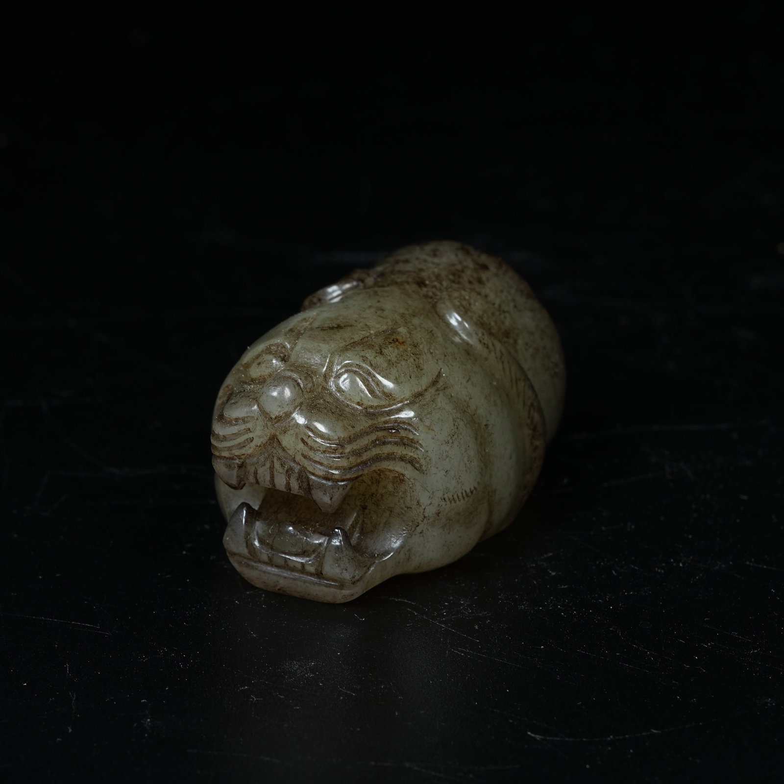 A ARCHAIC JADE ORNAMENT WITH BEAST HEAD: Archaic Jade Ornament with Beast Head