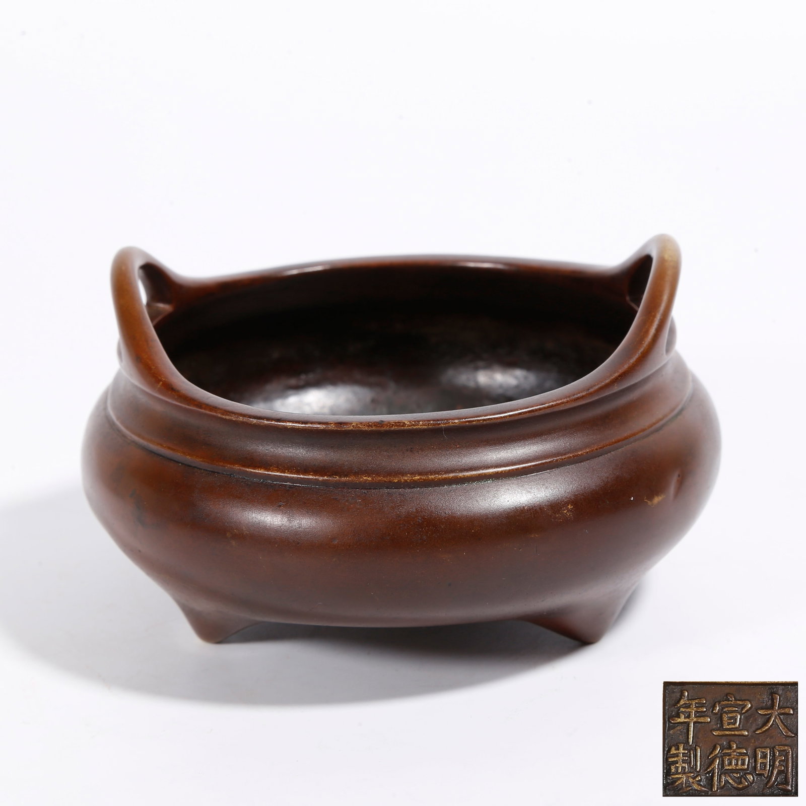 A BRONZE TRIPOD CENSER WITH DOUBLE BRIDGE HANDLES: Bronze Tripod Censer with Double Bridge Handles