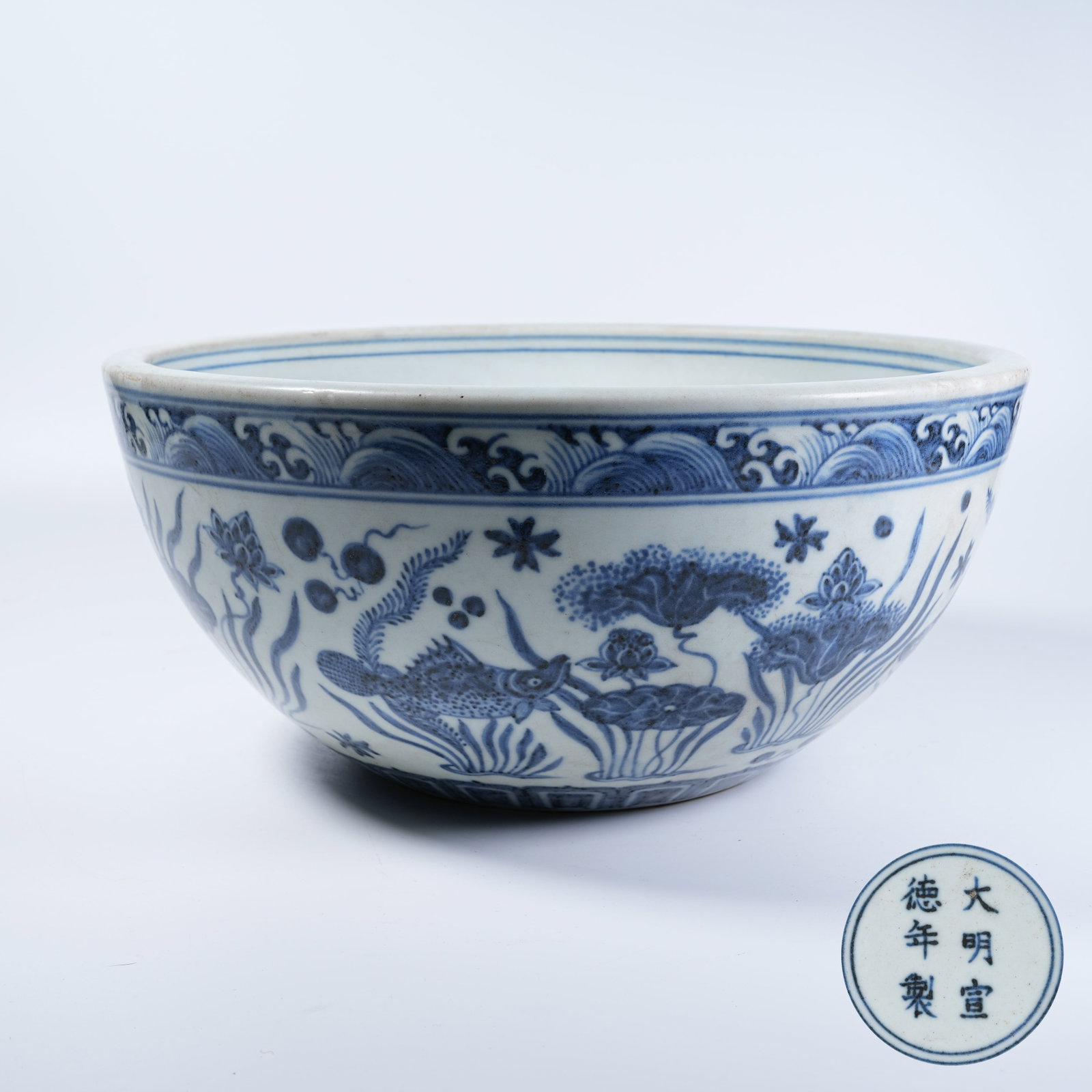 A TABLE CYLINDER WITH BLUE AND WHITE FISH ALGAE PATTERNS: Table Cylinder with Blue and White Fish Algae Patterns