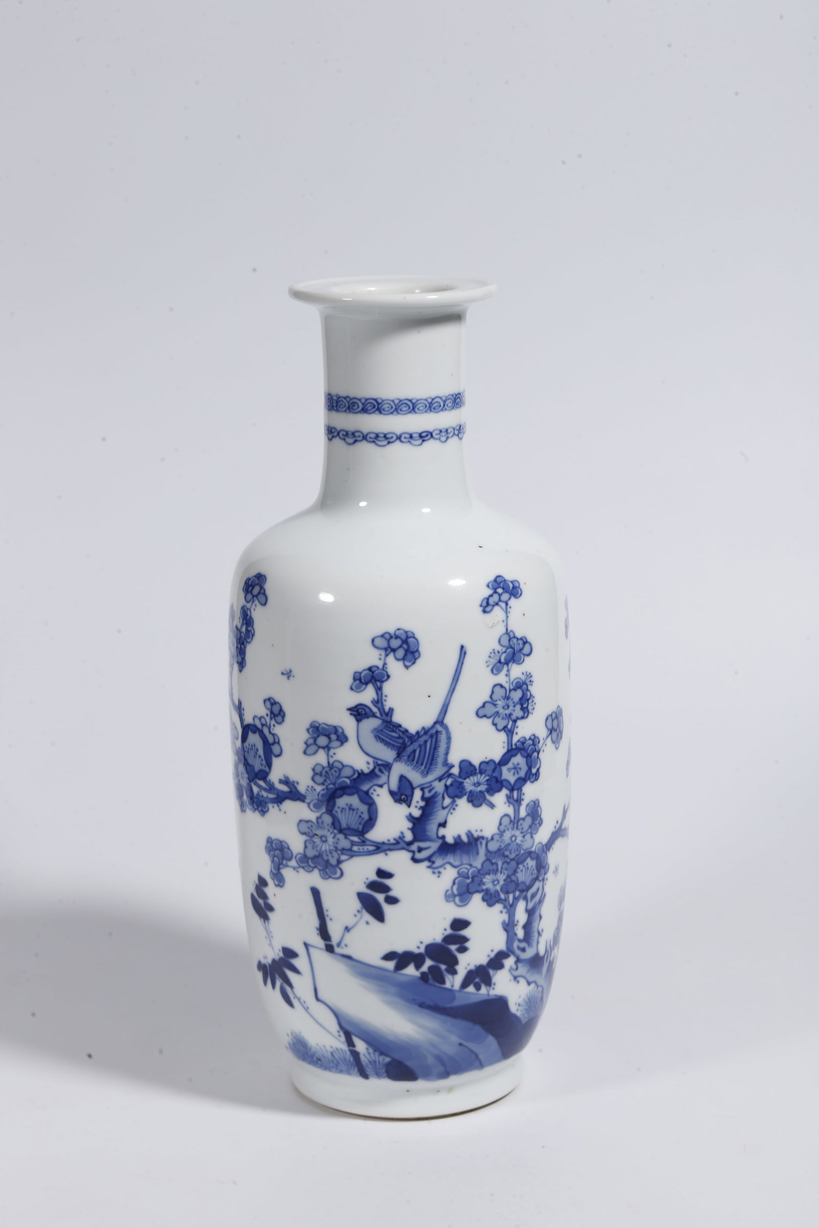 A BLUE AND WHITE DECORATIVE VASE WITH ROCK AND FLORAL PATTERN: Blue and White Decorative Vase with Rock and Floral Pattern