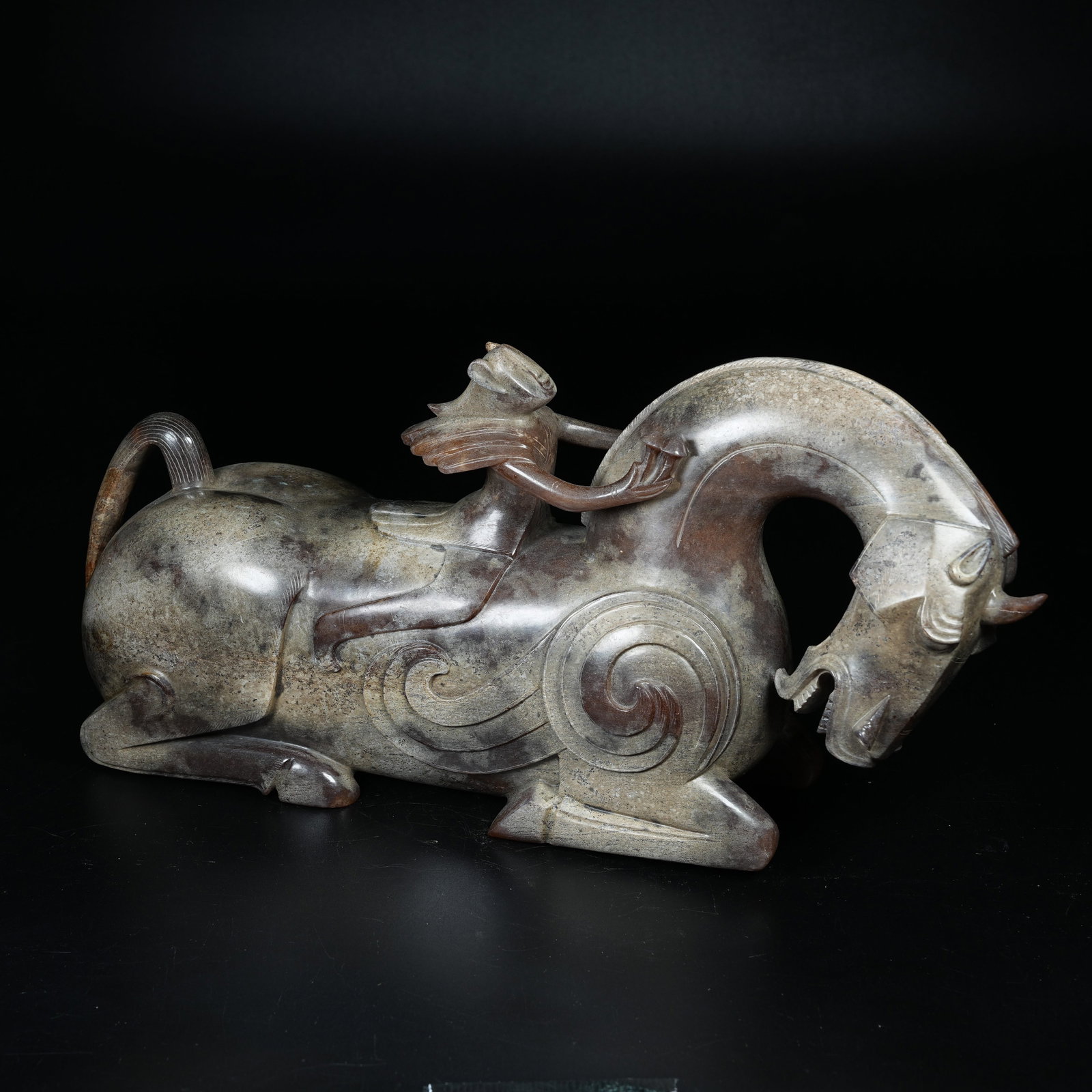 A ARCHAIC JADE ORNAMENT OF WINGED IMMORTAL RIDING BEAST: Archaic Jade Ornament of Winged Immortal Riding Beast