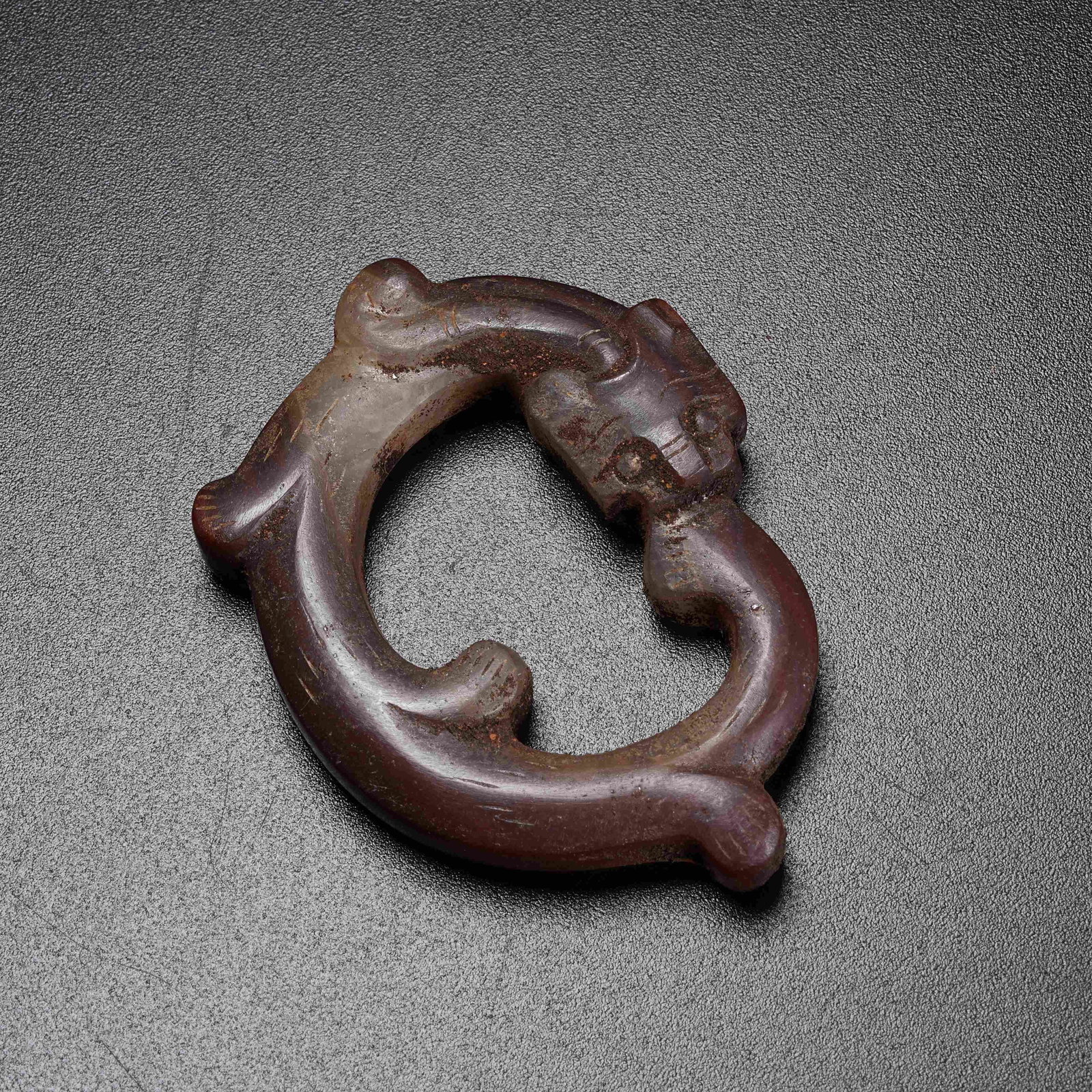 A WARRING STATES RED AGATE PENDANT WITH OUROBOROS DRAGON (1 of 7)