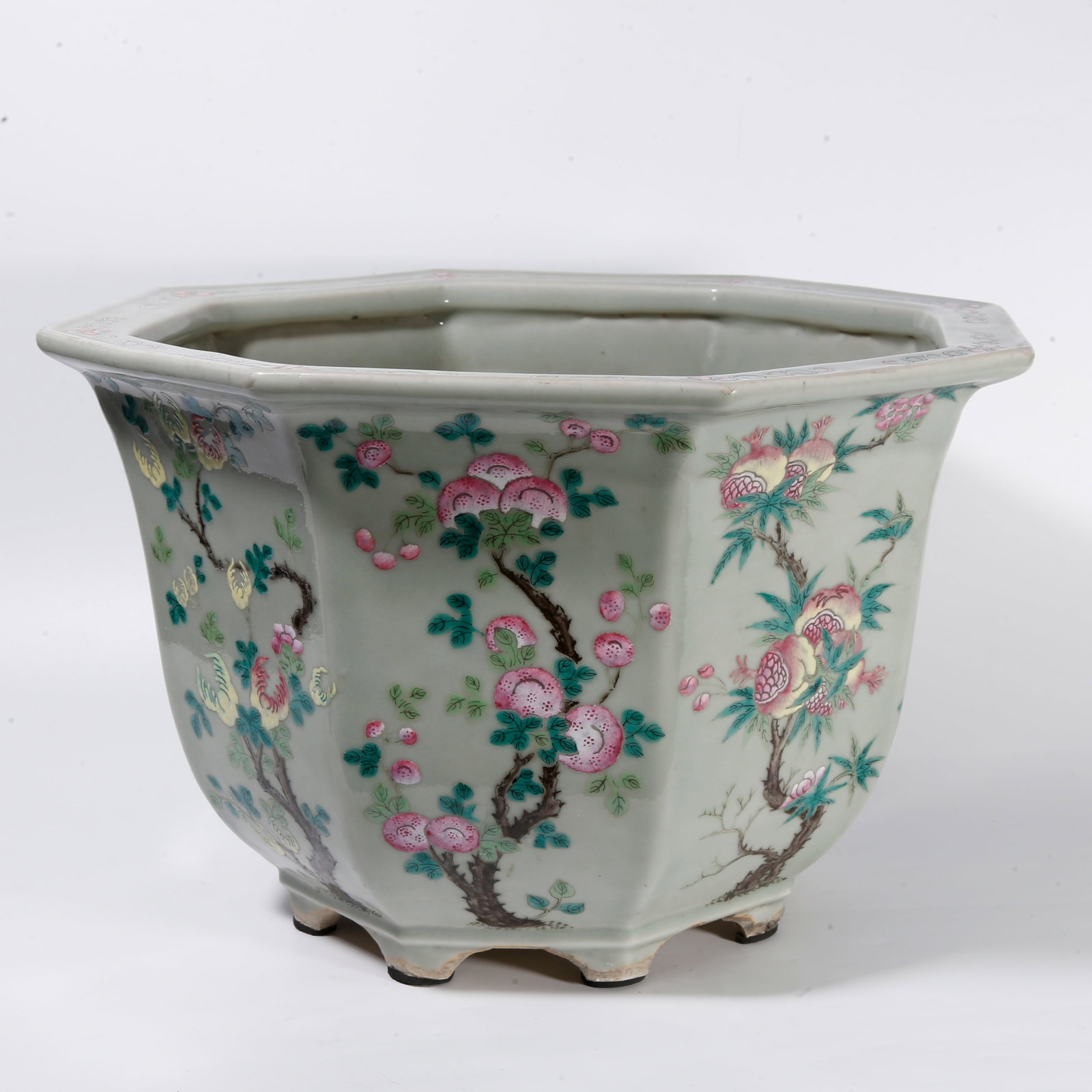 A FAMILLE ROSE OCTAGONAL FLOWER POT WITH FOLDED AUSPICIOUS FRUIT MOTIF: Famille rose octagonal flower pot with folded auspicious fruit motif