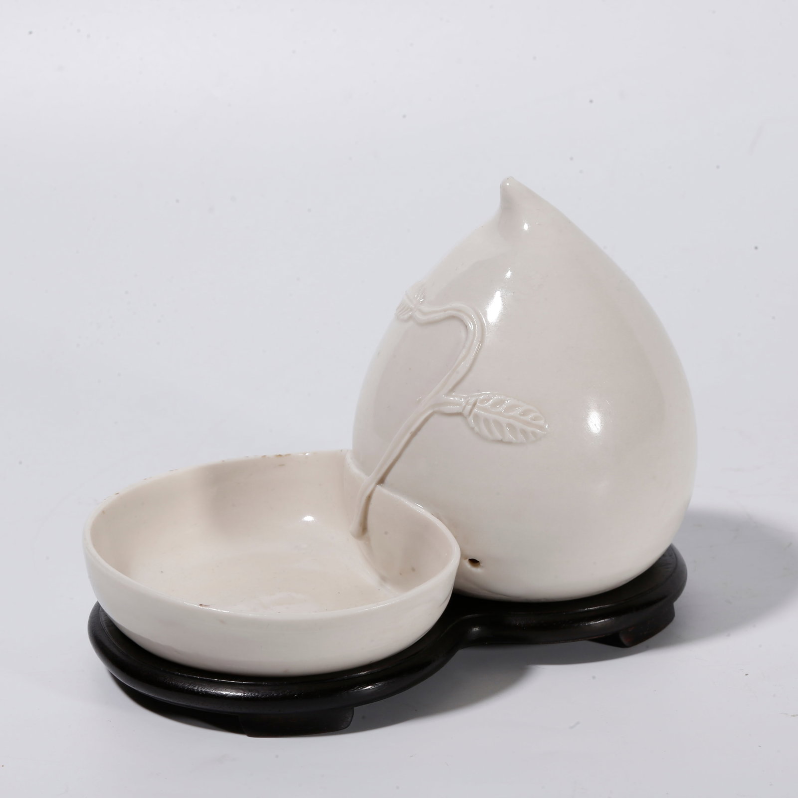 A DING KILN PEACH?SHAPED WASHER: Ding kiln peach?shaped washer