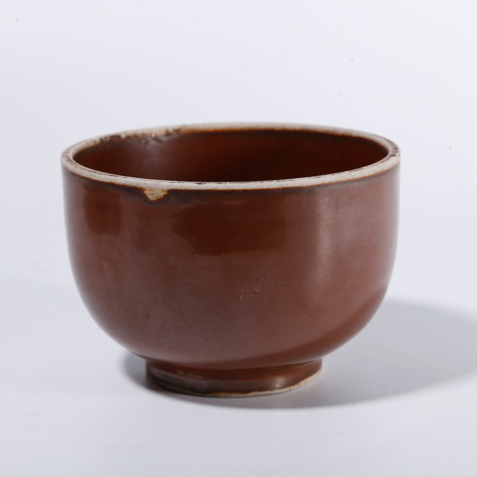 A DING WARE PERSIMMON?GLAZED CUP: Ding ware persimmon?glazed cup
