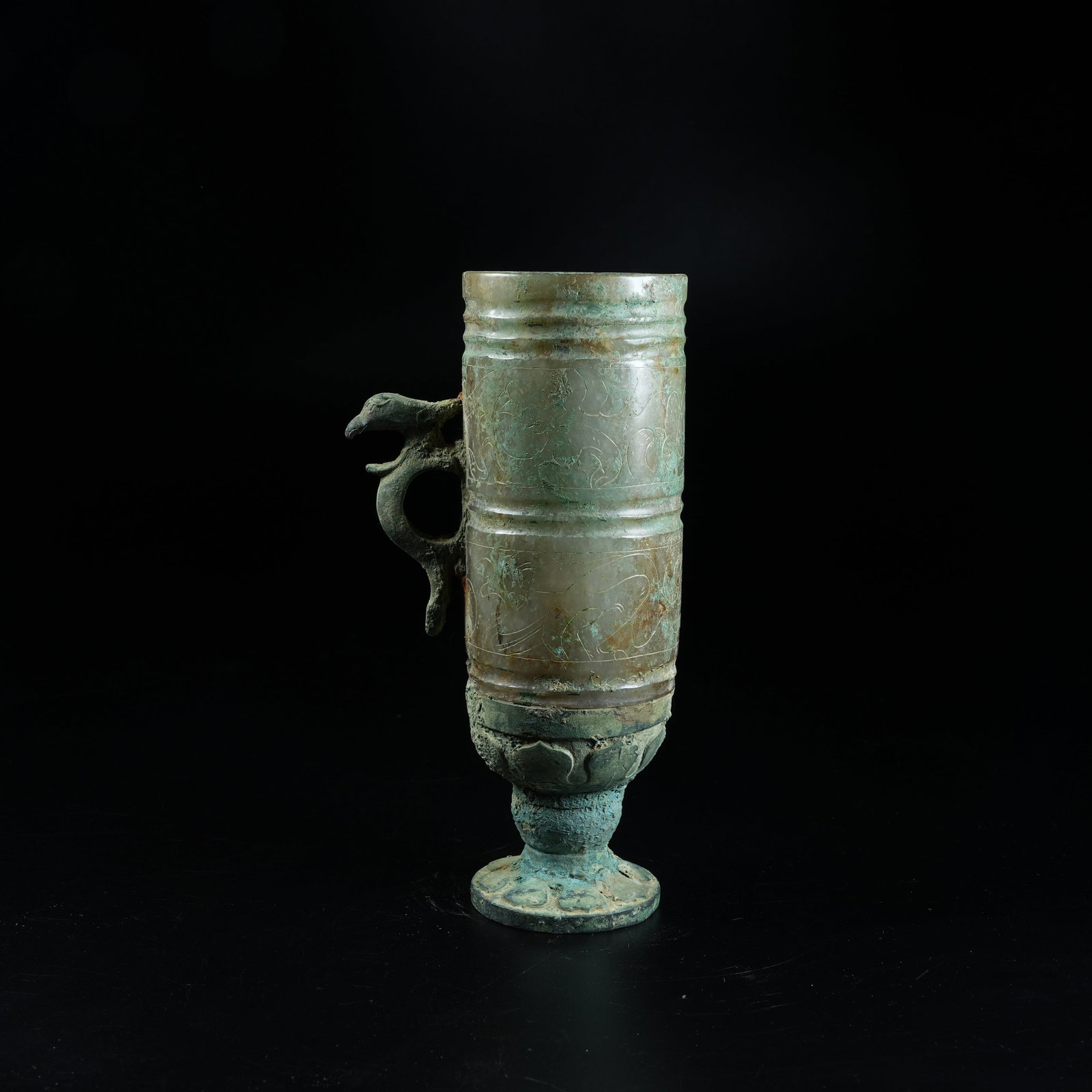 A ANCIENT JADE STEM CUP WITH PHOENIX HANDLE CARVED WITH DRAGON PATTERNS: Ancient Jade Stem Cup with Phoenix Handle Carved with Dragon Patterns