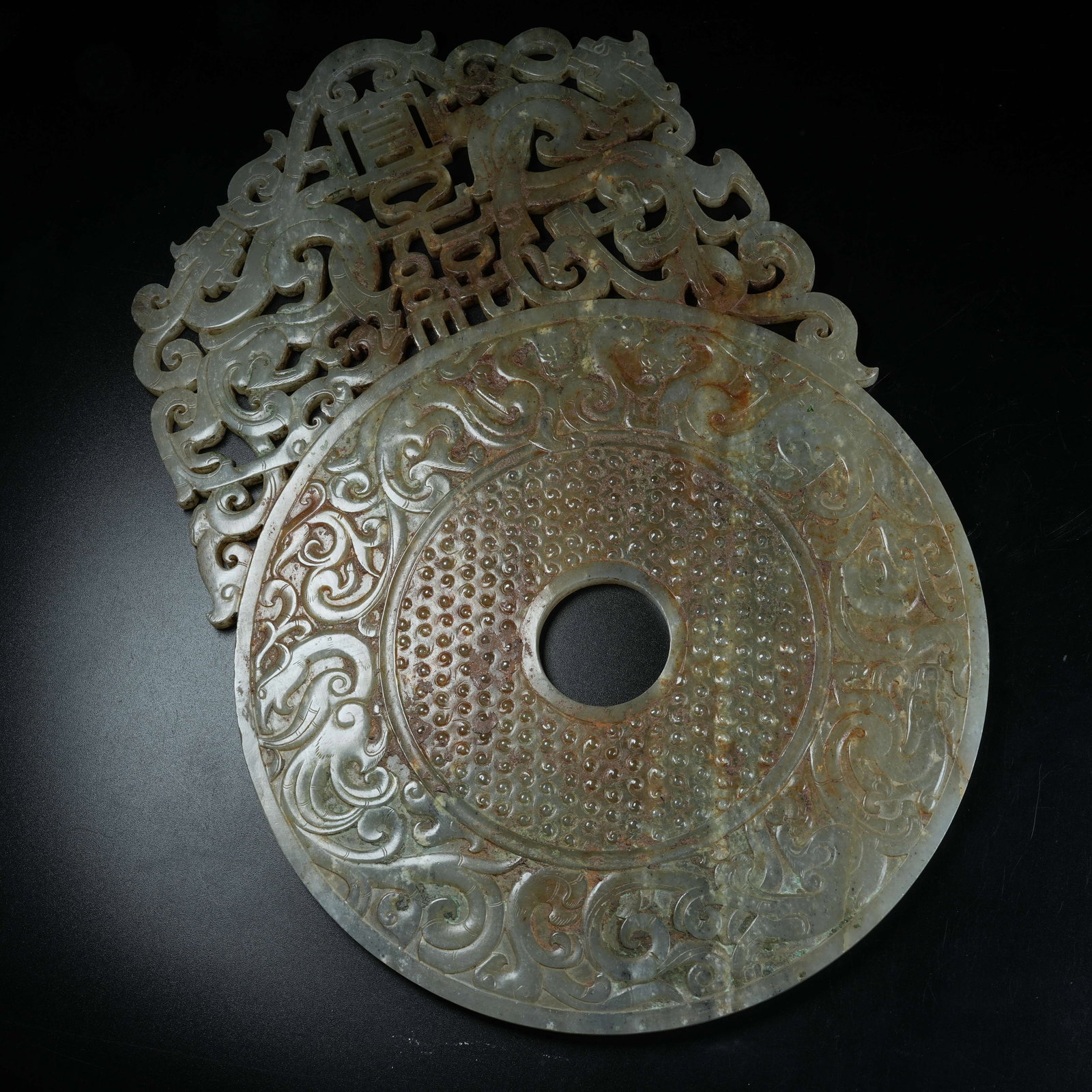 A ANCIENT JADE OPENWORK BI DISC WITH DESCENDANT BLESSING MOTIFS EXTENDING BEYOND RIM: Ancient Jade Openwork Bi Disc with Descendant Blessing Motifs Extending Beyond Rim