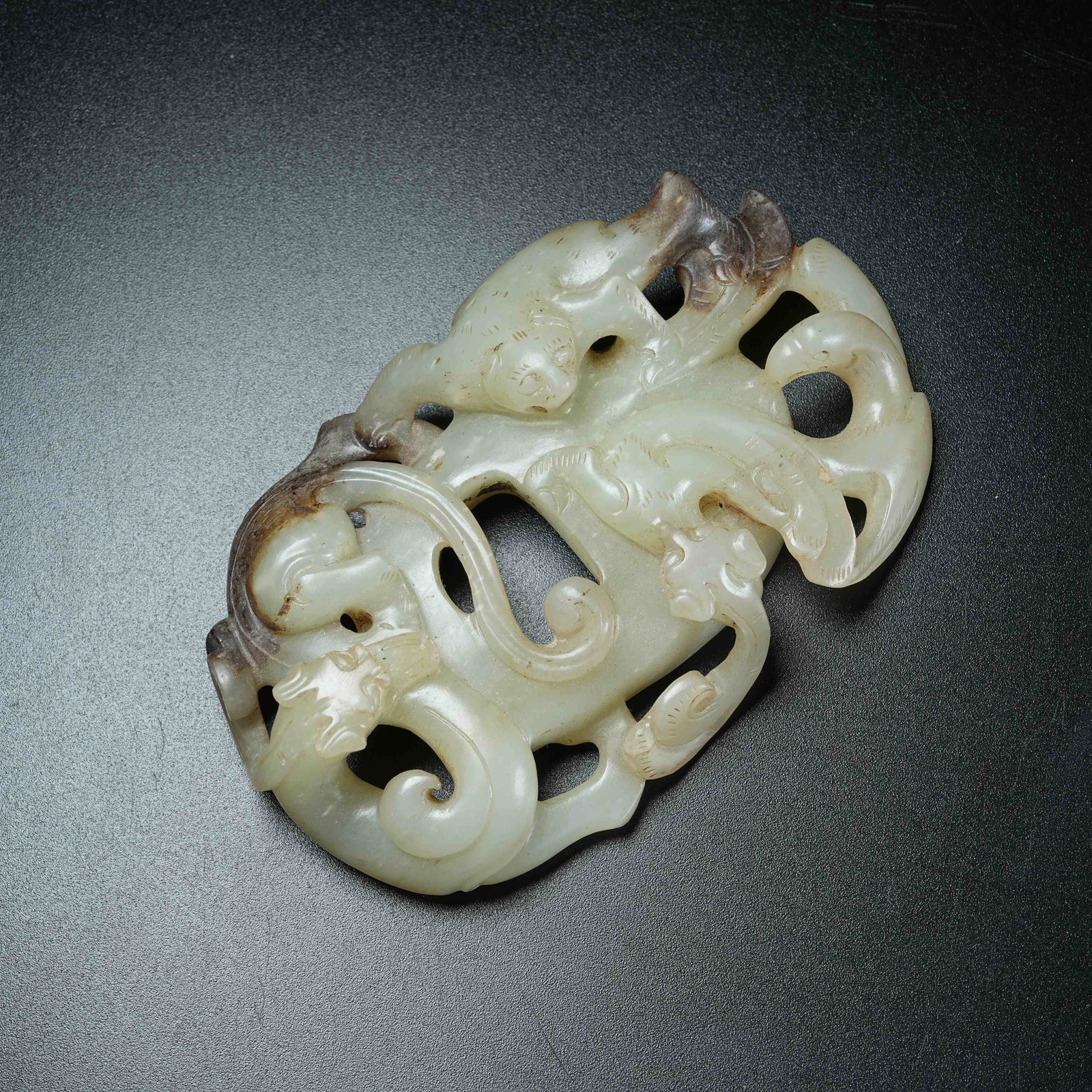 A ANCIENT JADE HEART-SHAPED PENDANT CARVED WITH CHI DRAGON PATTERNS: Ancient Jade Heart-shaped Pendant Carved with Chi Dragon Patterns
