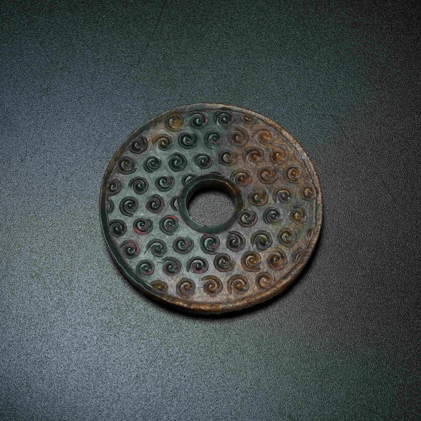 A ANCIENT JADE BI DISC WITH HOOKED CLOUD PATTERN: Ancient Jade Bi Disc with Hooked Cloud Pattern