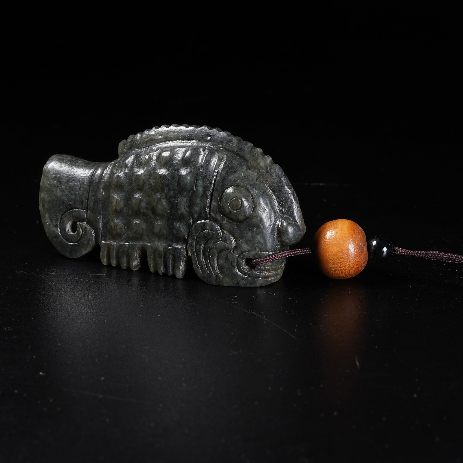 A HETIAN GREEN JASPER FISH PENDANT: Hetian Green Jasper Fish Pendant