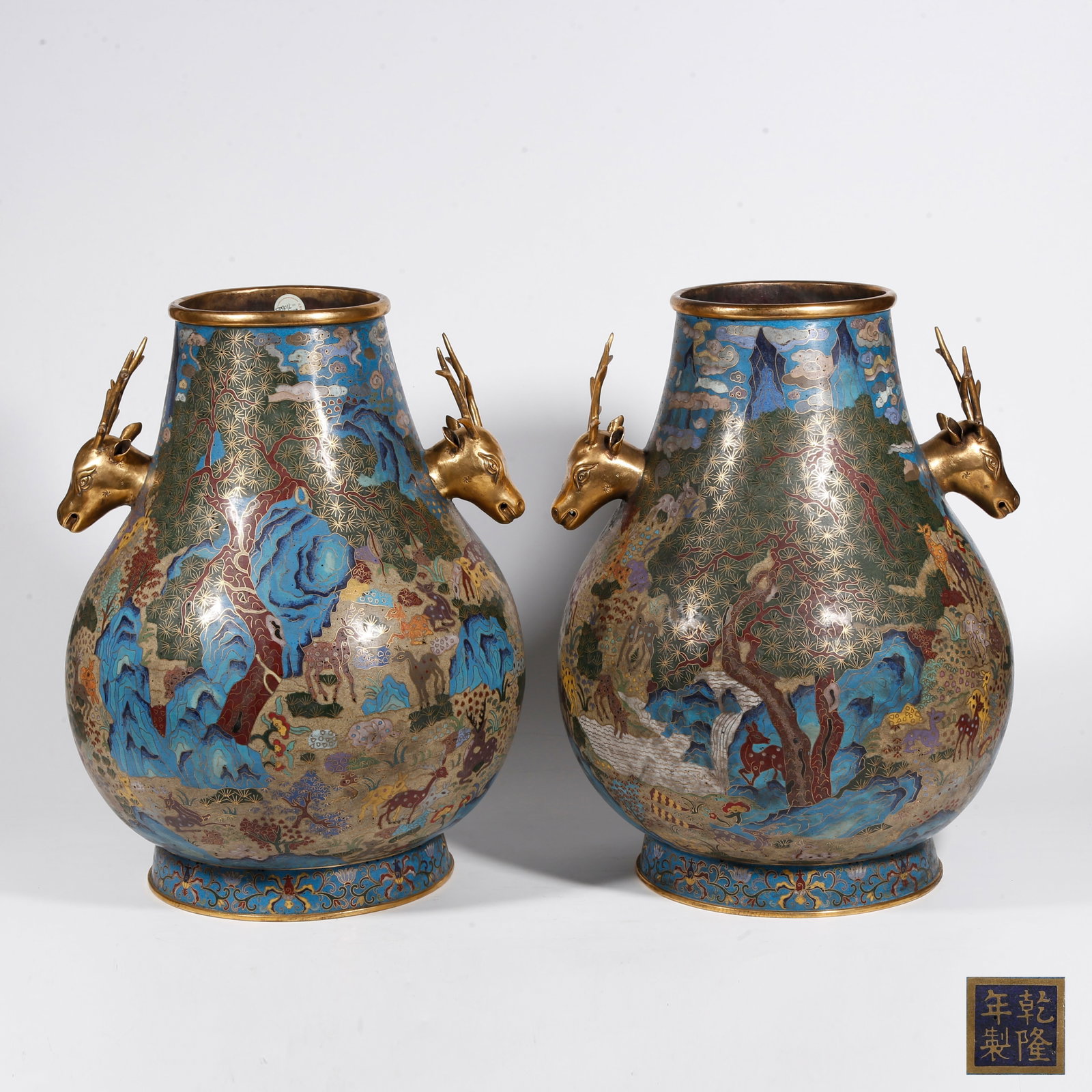 A PAIR OF CLOISONNE DEER?HEAD ZUN VESSELS WITH GROUP?DEER MOTIFS ON BRONZE BODY: Pair of Cloisonne Deer?Head Zun Vessels with Group?Deer Motifs on Bronze Body