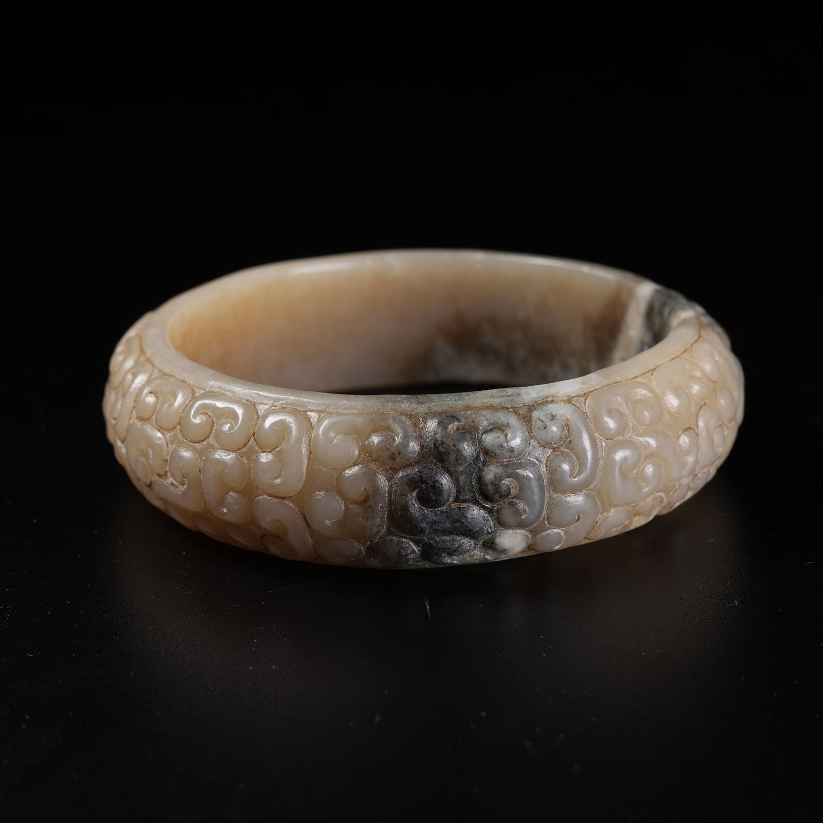 A ARCHAIC JADE BANGLE WITH HOOKED CLOUD PATTERN: Archaic Jade Bangle with Hooked Cloud Pattern
