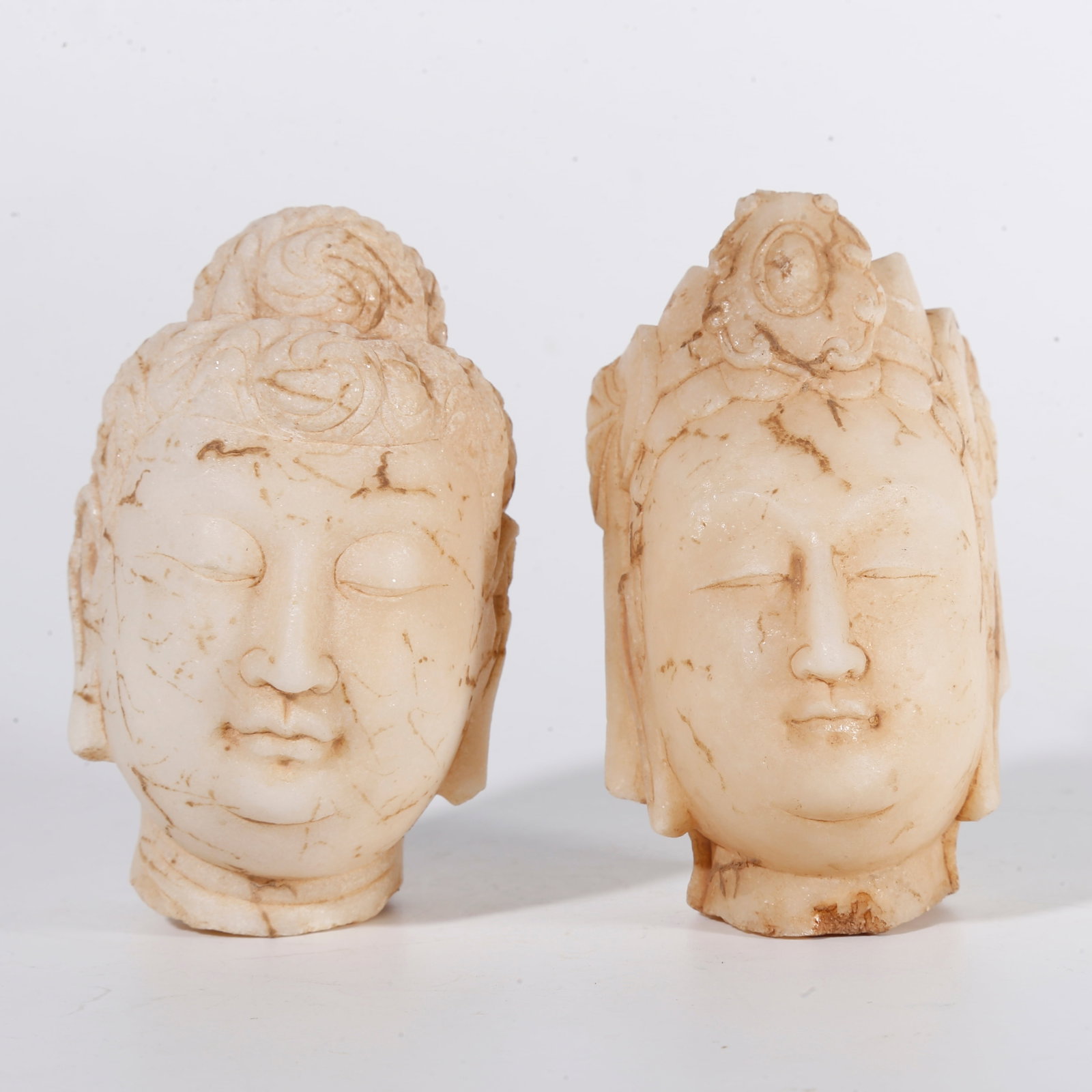 A WHITE MARBLE BUDDHA HEAD (SET) (1 of 9)