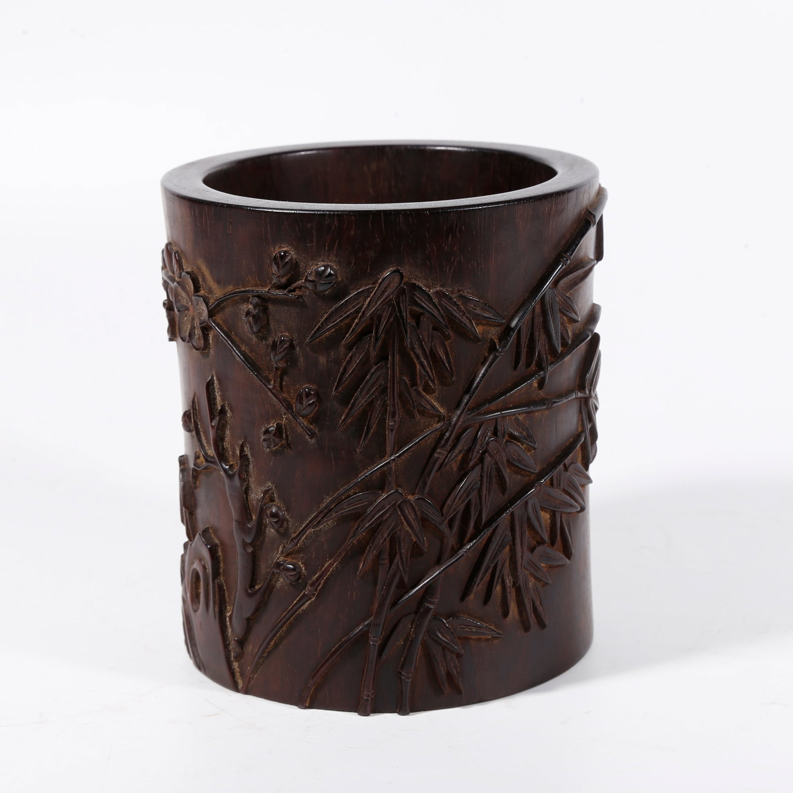 A BRUSH POT CARVED WITH BAMBOO AND PLUM PATTERN IN ZITAN WOOD: Brush pot carved with bamboo and plum pattern in zitan wood