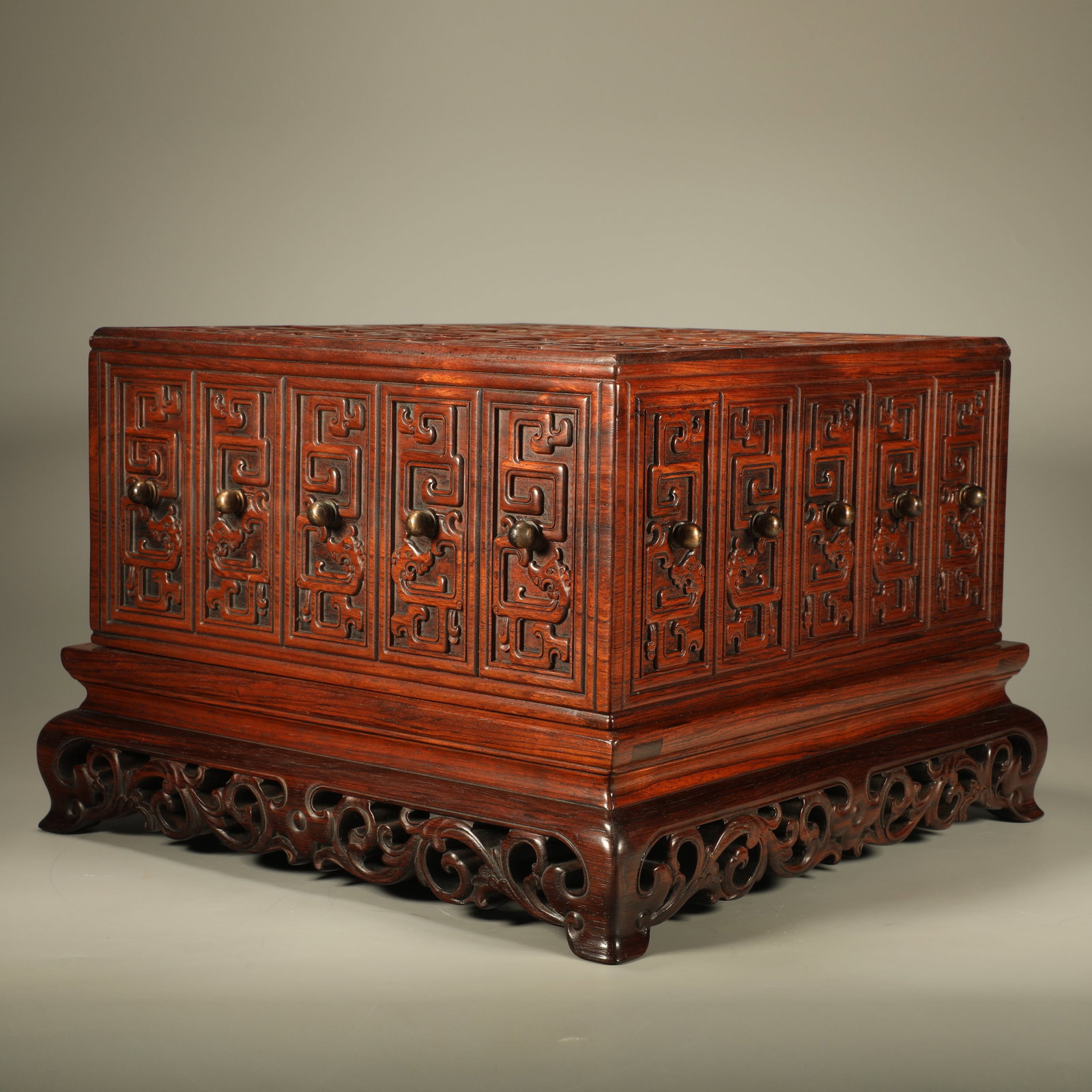 A HUANGHUALI BOX CARVED WITH INTERLOCKING DRAGON PATTERNS: Huanghuali Box Carved with Interlocking Dragon Patterns