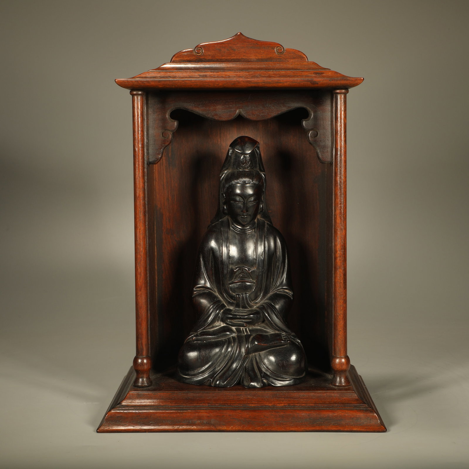 A HUANGHUALI BUDDHIST NICHE WITH SANDALWOOD AVALOKITESVARA STATUE: Huanghuali Buddhist Niche with Sandalwood Avalokitesvara Statue