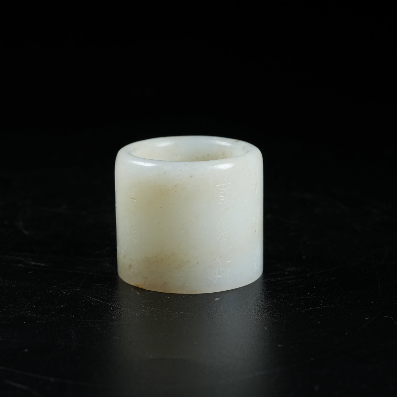 A HETIAN JADE THUMB RING WITH INSCRIPTIONS: Hetian Jade Thumb Ring with Inscriptions