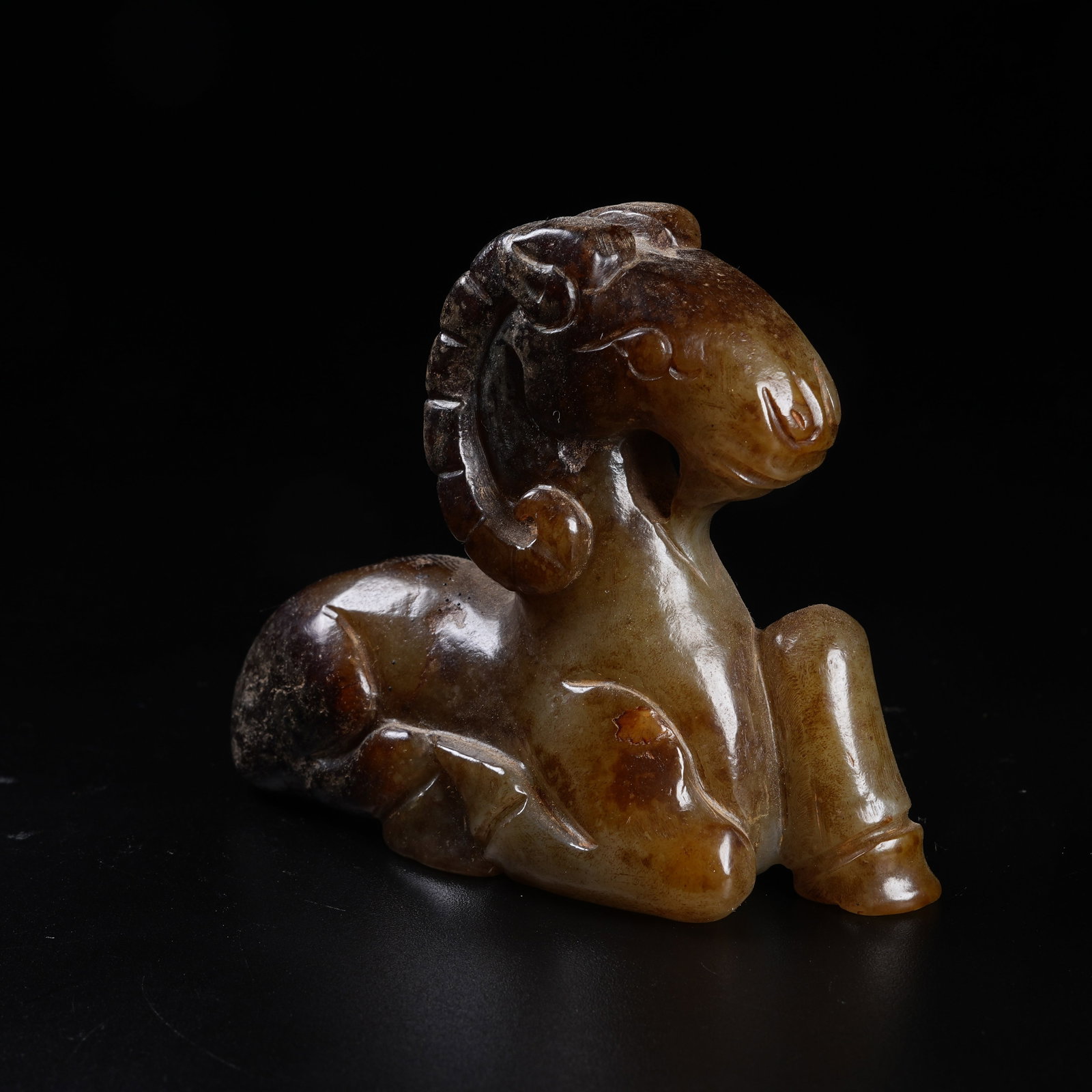 A ARCHAIC JADE RECUMBENT SHEEP ORNAMENT: Archaic Jade Recumbent Sheep Ornament