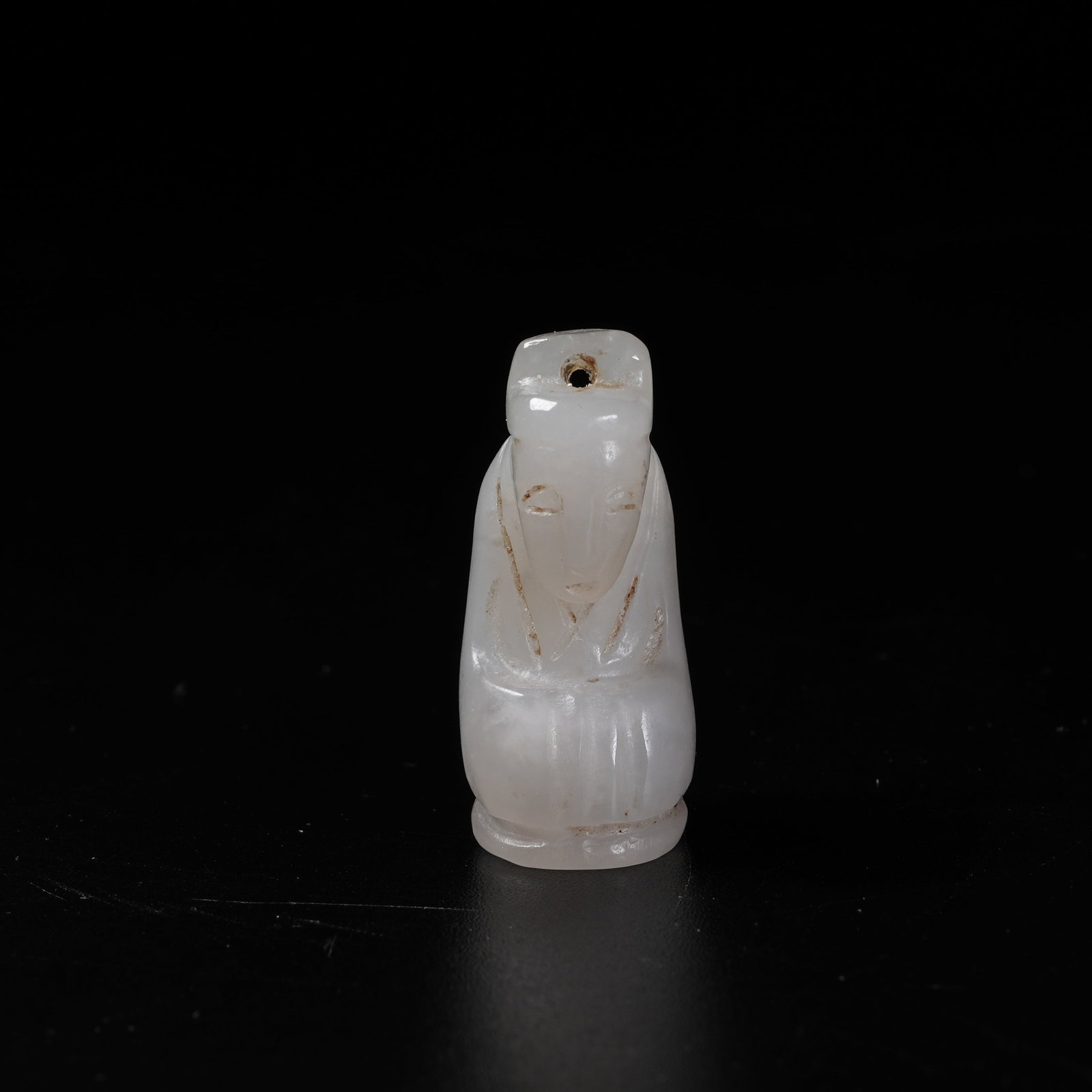 A HETIAN JADE KNEELING HUMAN PENDANT: Hetian Jade Kneeling Human Pendant
