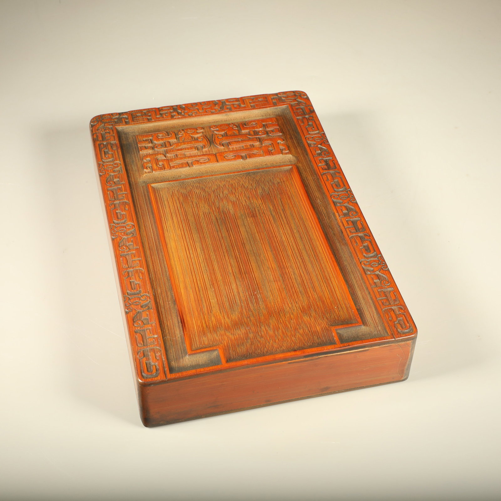 A BAMBOO INKSTONE CARVED WITH DRAGON PATTERNS AND INSCRIBED VERSES: Bamboo Inkstone Carved with Dragon Patterns and Inscribed Verses
