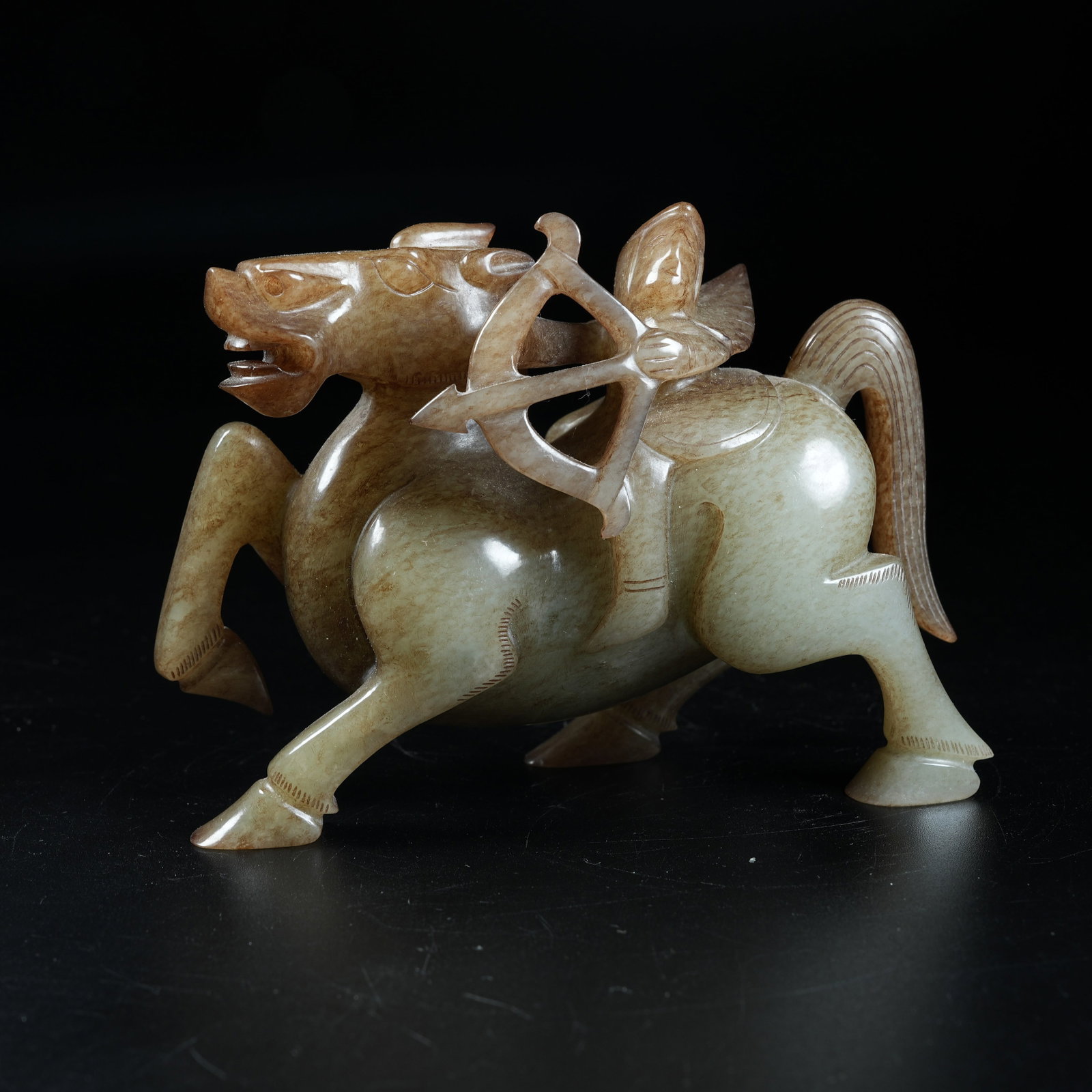 A ANCIENT JADE ORNAMENT OF FEATHERED MAN RIDING DIVINE BEAST: Ancient Jade Ornament of Feathered Man Riding Divine Beast