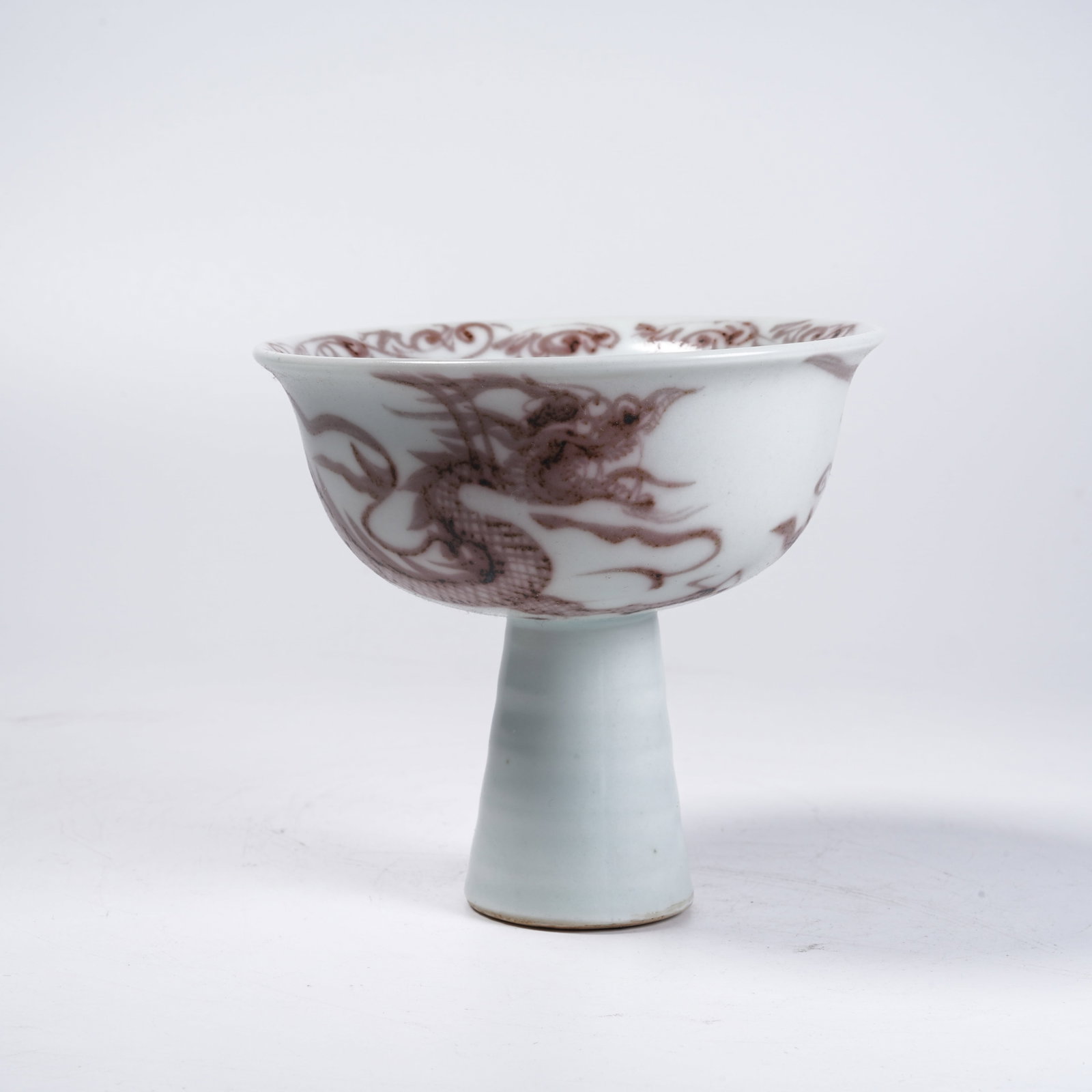 A IRON RED STEM BOWL WITH CLOUD AND DRAGON PATTERNS: Iron Red Stem Bowl with Cloud and Dragon Patterns