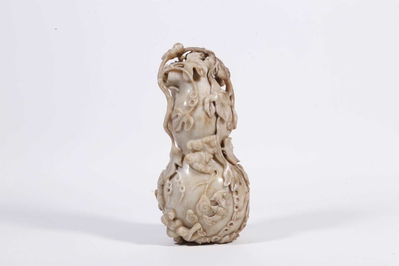 A HETIAN JADE GOURD-SHAPED ORNAMENT (1 of 9)