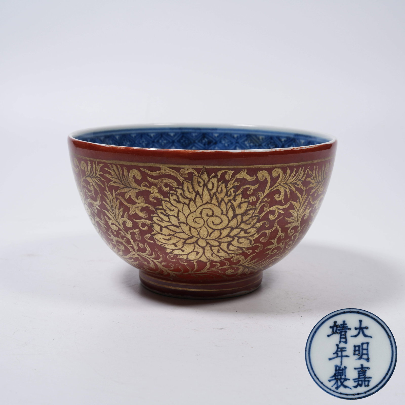 A IRON RED BOWL WITH GILDED INTERLOCKING FLORAL PATTERNS: Iron Red Bowl with Gilded Interlocking Floral Patterns