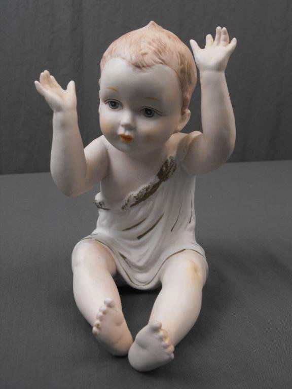 Vintage Bisque Piano Baby: A large sized Vintage Bisque Piano Baby, crossed swords mark on underside. 1950s. 6 "