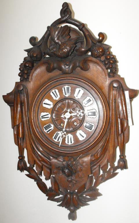 19th Century carved Walnut Wall Clock: A fancy walnut heavy carved wall clock. 27 x 20.