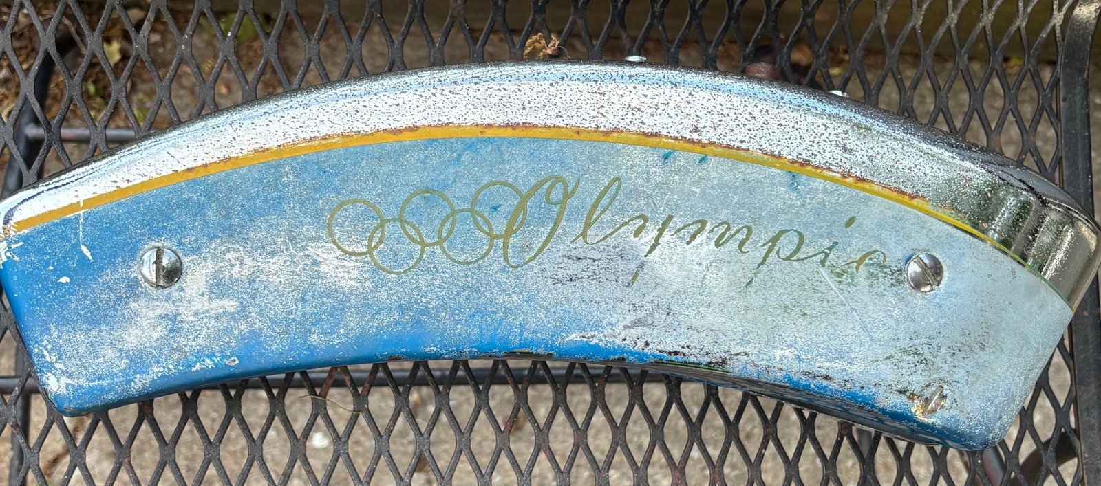 1950s Olympic Bicycle Horn Tank: bicycle horn tank, specifically from an Evans-Colson Olympic model.These tanks were mounted to the frame of "cruiser" or "balloon tire" bicycles and often contained a battery-operated horn.