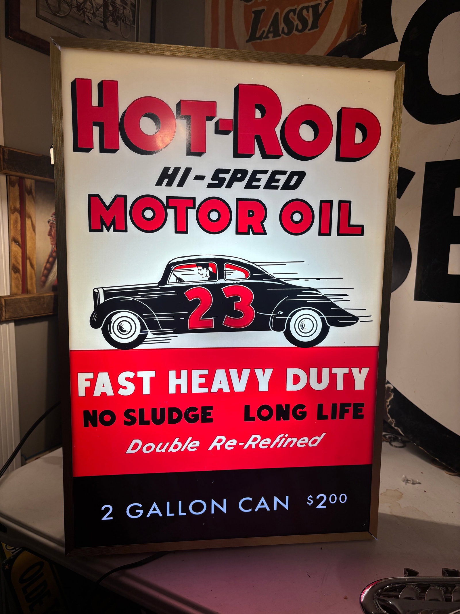 Hot-Rod Hi-Speed Motor Oil. Lighted Sign: Hot-Rod Hi-Speed Motor Oil Lighted Sign. Electric Speed Shop light up Motor Oil Advertising sign. Gold colored ribbed metal frame. Screen Printed very hard plastic insert. Pressed wood back. Lighting