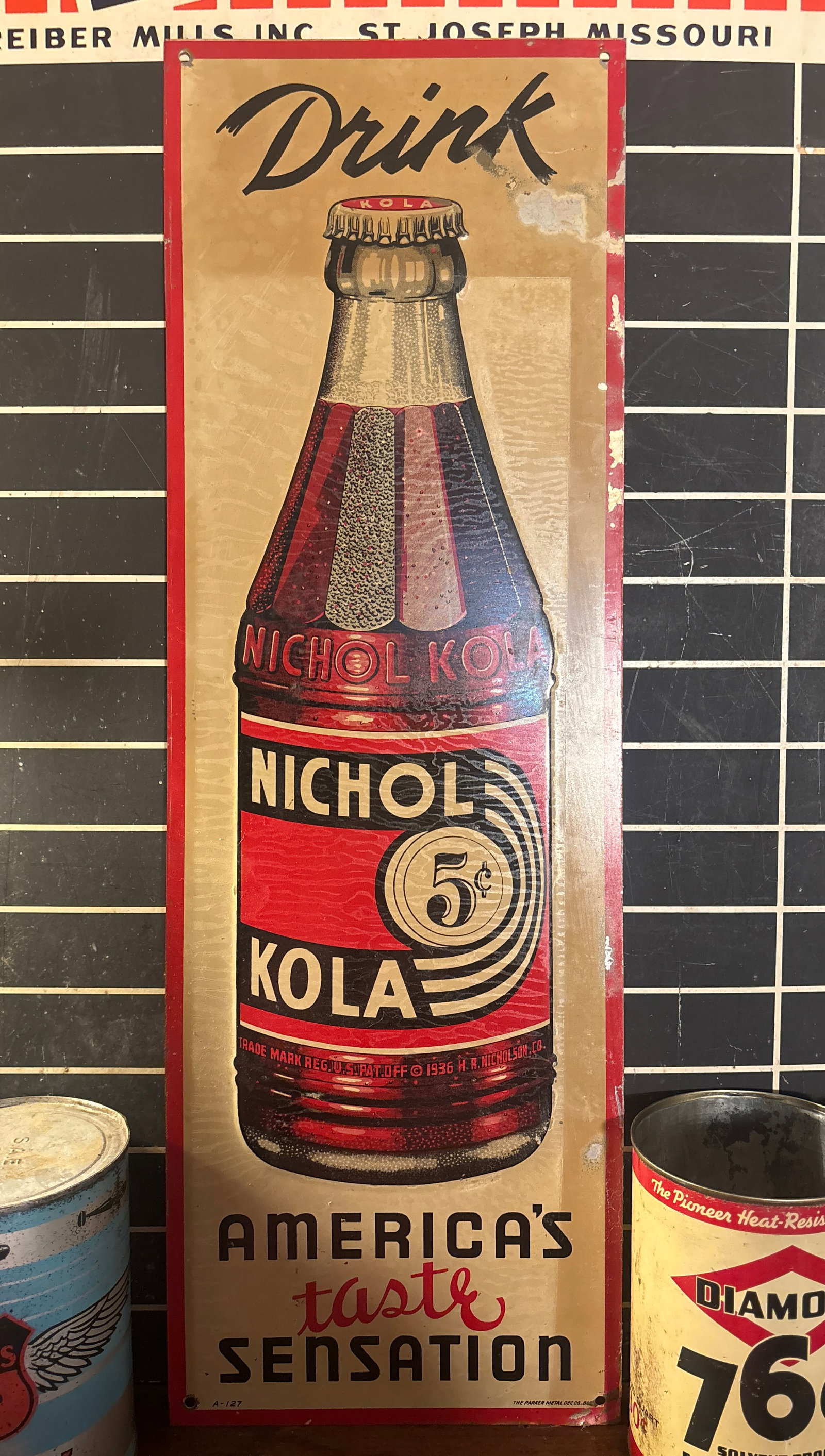 1940s Nichol Kola 5 cent Vertical Tin Tacker: 1940s Nichol Kola 5 cent Vertical Tin Tacker. Embossed green back. Sign shows some wear , has a good look. Displays well. Measures 8”x24”. Flat rate shipping is $20. Or pick up in St.