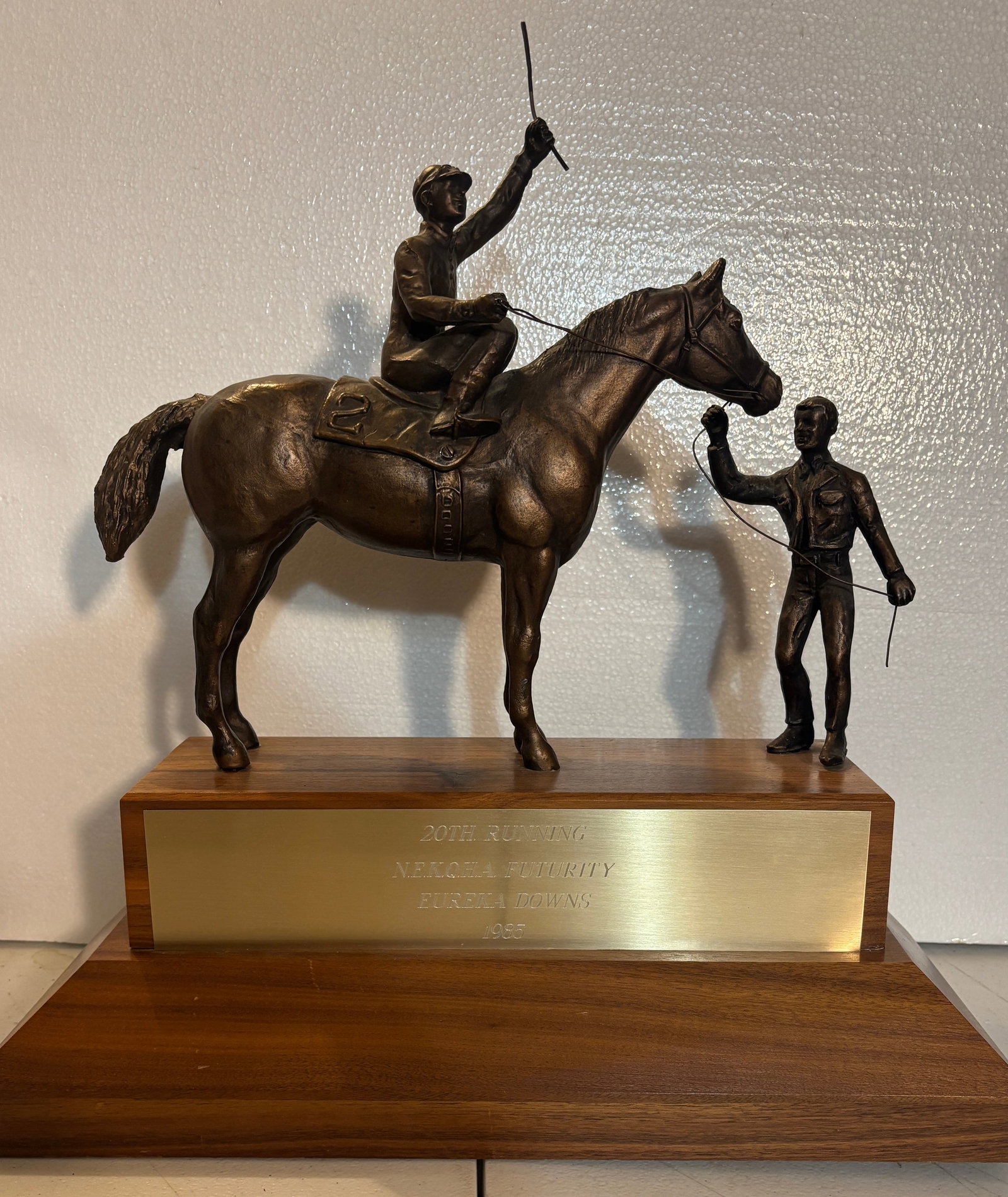 Large Bronze Horse Racing Trophy Eureka Downs 1985: A custom-mounted bronze equestrian trophy presented for the 20th Running of the NEKCOBA Futurity at Eureka Downs in 1985. The trophy features a detailed sculpture of a jockey celebrating atop a