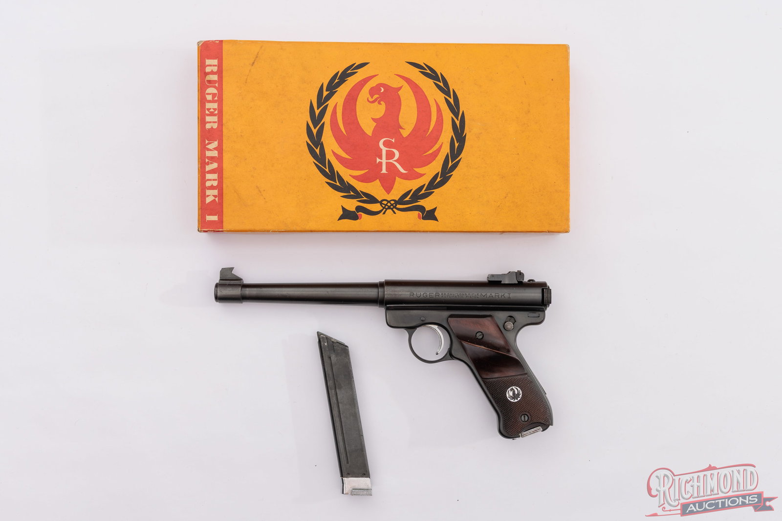 1965 Sturm Ruger Mark I Target .22 LR Semi-Auto Pistol In Original Yellow Box: Manufactured by Sturm Ruger in 1965. This first generation target pistol features a 6-1/2" blued tapered barrel with rear micrometer adjustable notch sight and target blade front sight. Blued finish