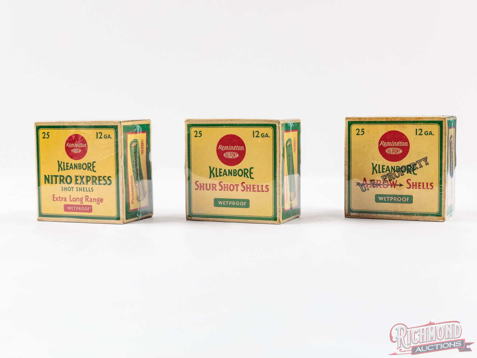 Three Factory Full Remington DuPont 12 GA U.S. Property Stamped Shotshell Boxes: All three boxes are factory full Remington DuPont 25 round 12 gauge, shotshell boxes with yellow, green and red print labels. One is a Kleanbore Arrow shells with the U.S. Property stencil stamp