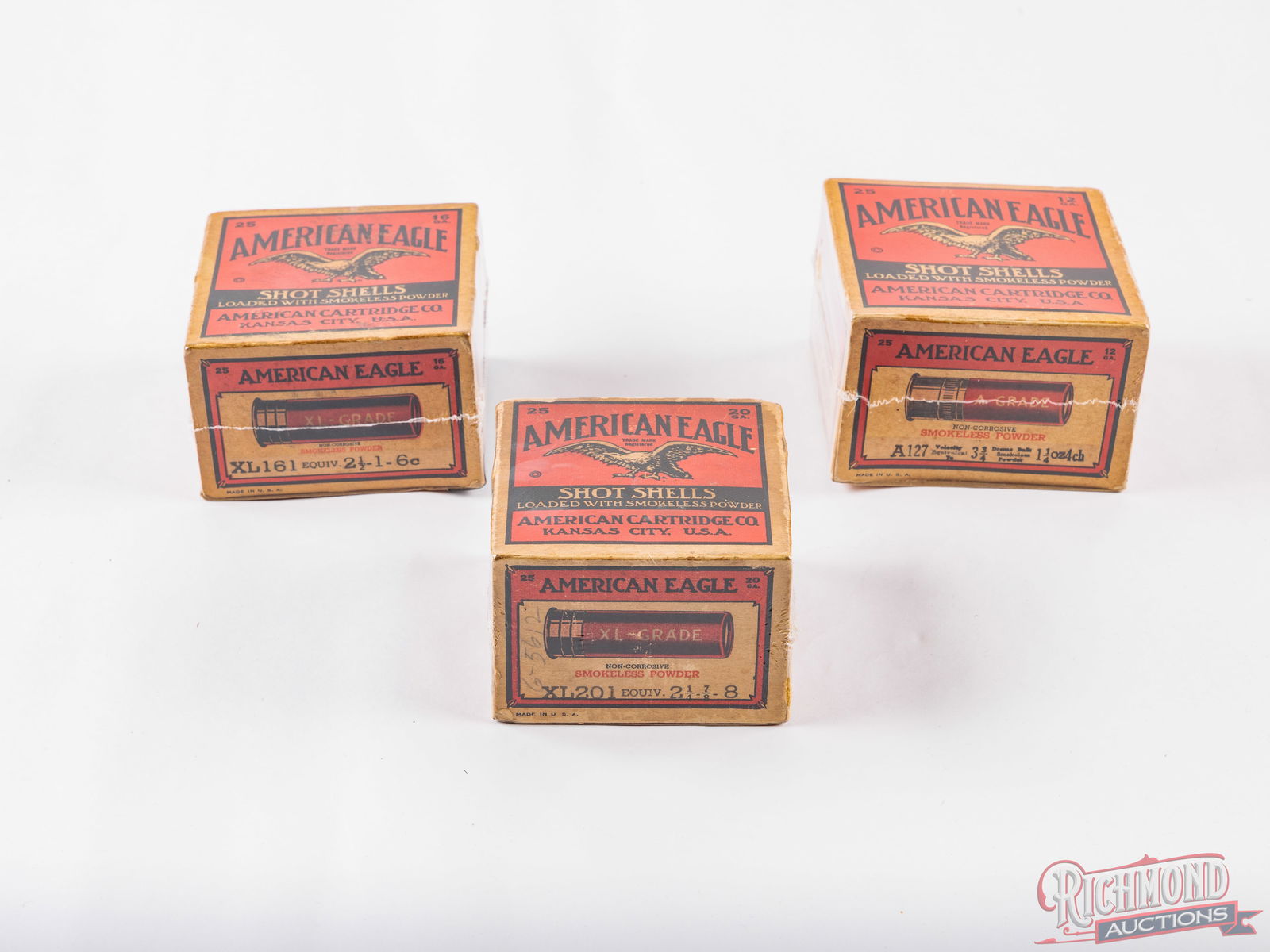 Three Collectible American Eagle Shotshell Boxes 20, 16 and 12 Gauge: Three collectible American Eagle one piece shotshell boxes. All buff colored 25 round boxes with the red and black Eagle trade mark print. 20 gauge box consist of 19 factory rounds, XL-grade, 2-1/4