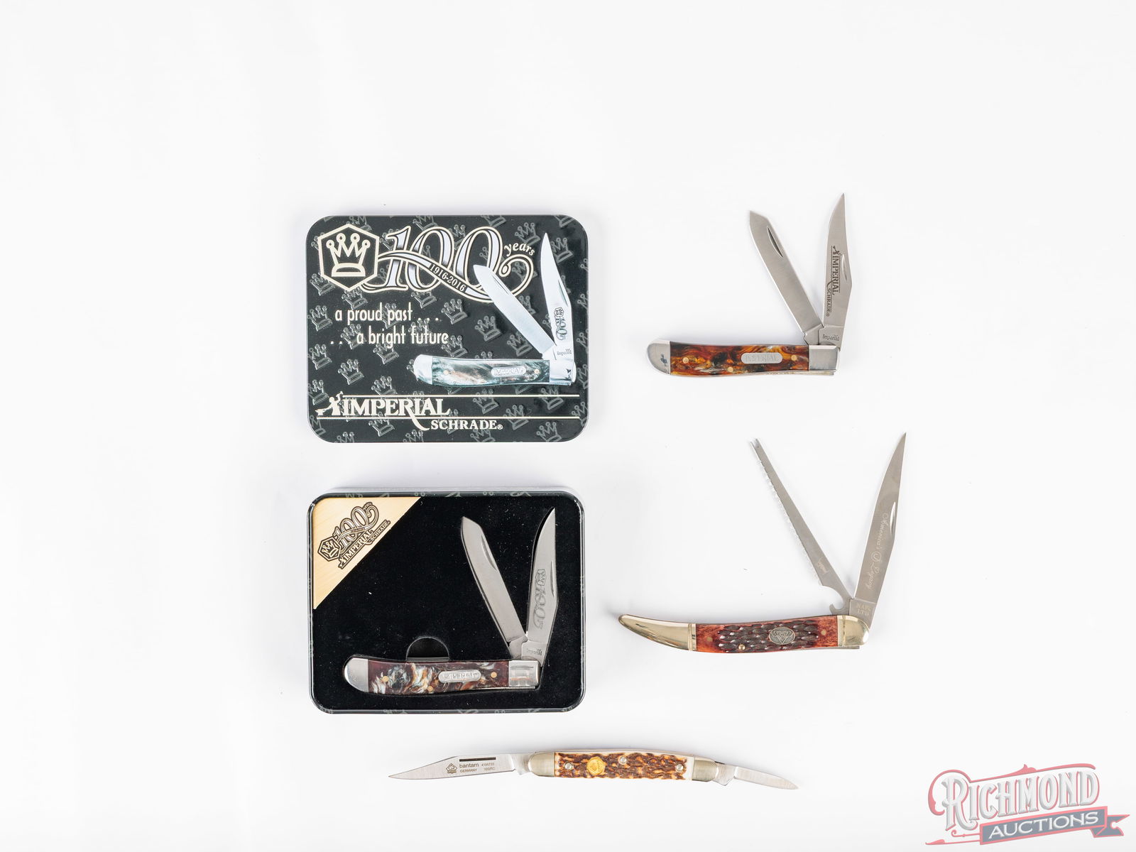 Four Unused Folder Pocket Knives Imperial, Puma & North American Legacy In Original Boxes: Two Schrade Imperial model IMP15T Trapper two blade folders. Both feature pearl like acrylic handles, steel liners and nickel bolsters. One has the 100 year etched on the blade and comes in a 100