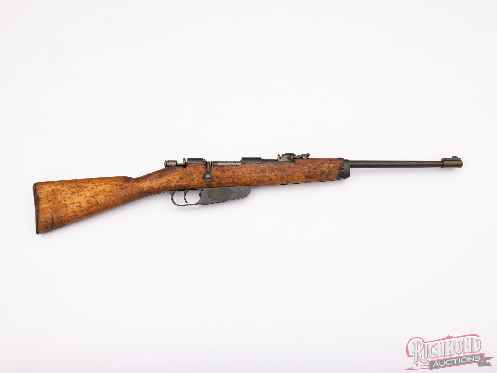 Italian M.91 Carcano Cavalry Carbine 6.5x52 Caliber: This Carcano rifle was manufactured in Italy at the Brescia Armory in 1942. It is chambered in 6.5x52 Carcano with an 18 1/2" barrel. It is fitted with an inverted "V" blade style front sight and rear