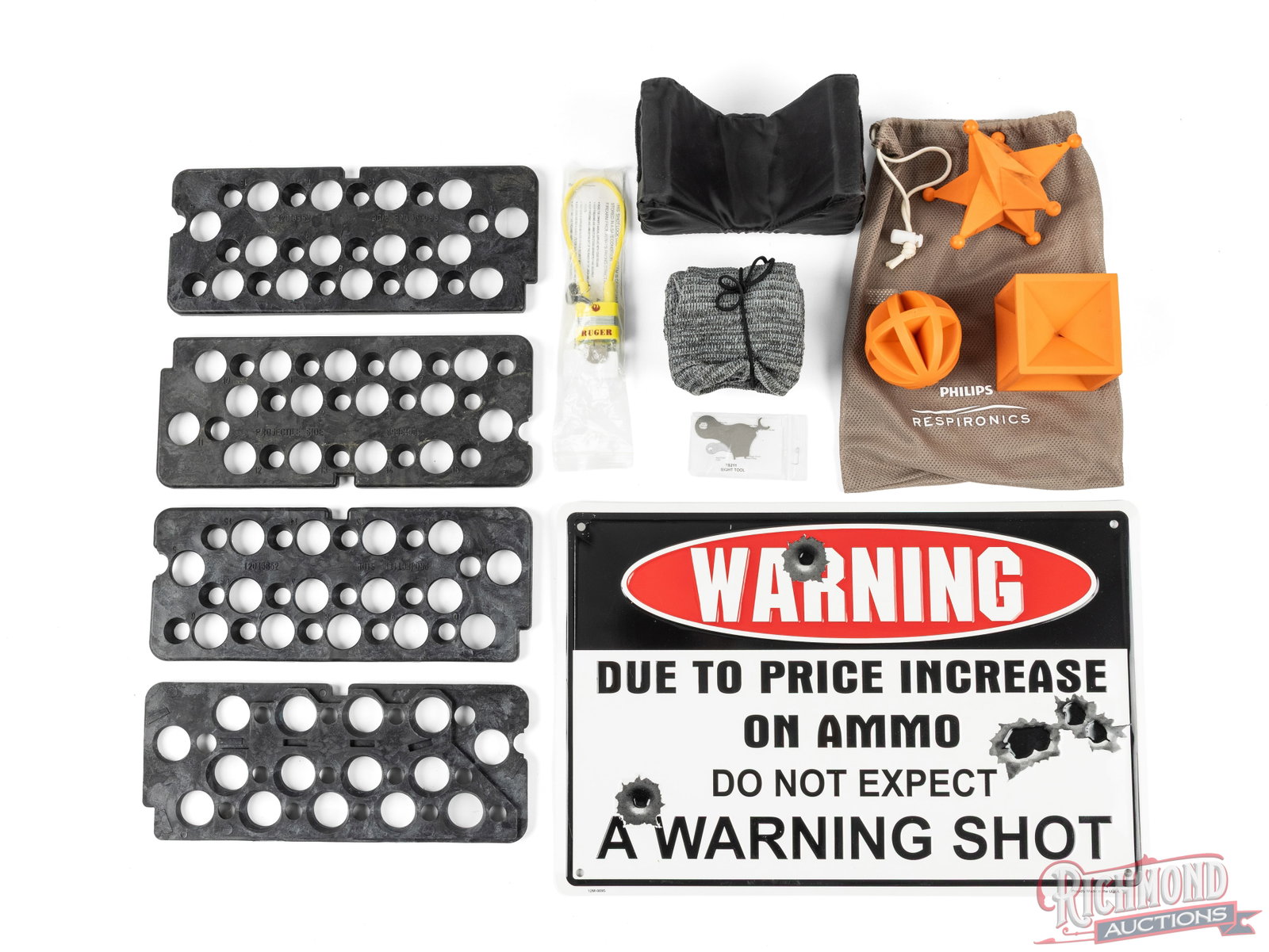 Shooter's Lot of Targets, Metal Sign, And Gun Sock: In this lot is 4 plastic shelves used in ammunition storage cans, a gun sock, padded rest, 3 plastic shooting targets, gun lock, and a metal sign. Condition GOOD TO VERY GOOD