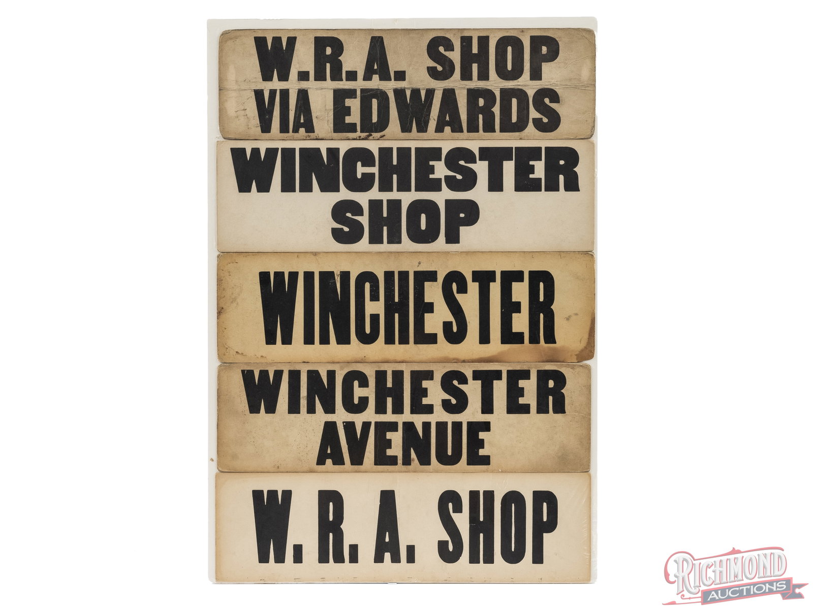 Five Winchester Shop Cardboard Signs: This is a set five of Winchester Shop signs. Each sign measures 17"x 5" and are shrink wrapped to a foam board. Each sign is different but have Winchester or WRA on each one. Condition GOOD
