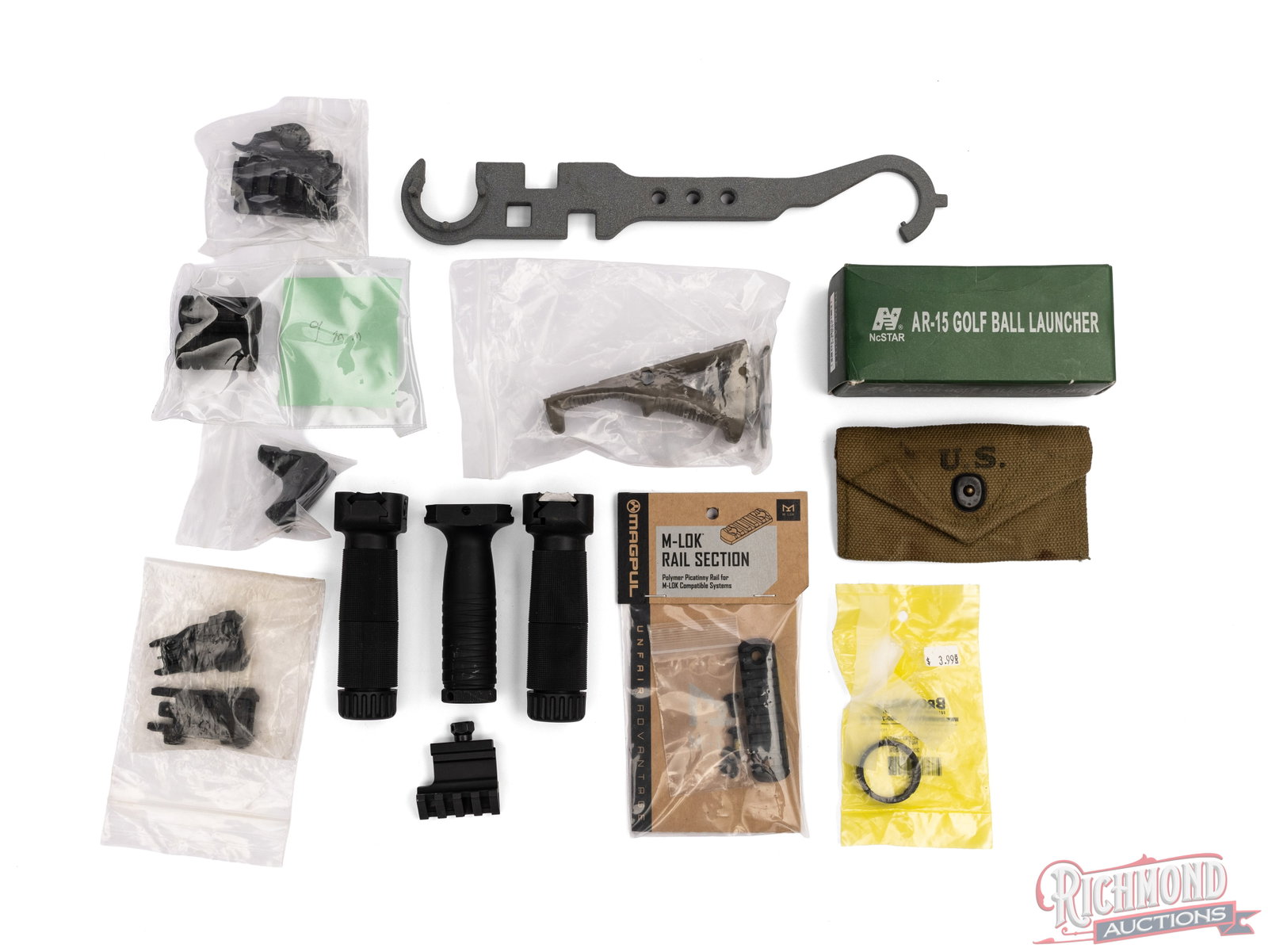 AR Parts Lot With Grips, Tools, Sights, And Golf Ball Launcher: This lot contains many parts that can be used on AR platform and other rifles. Included is a NcStar AR-15 Golf Ball launcher, 2 9mm muzzle breaks, a set of Magpul flip up sights, an AR wrench, 3