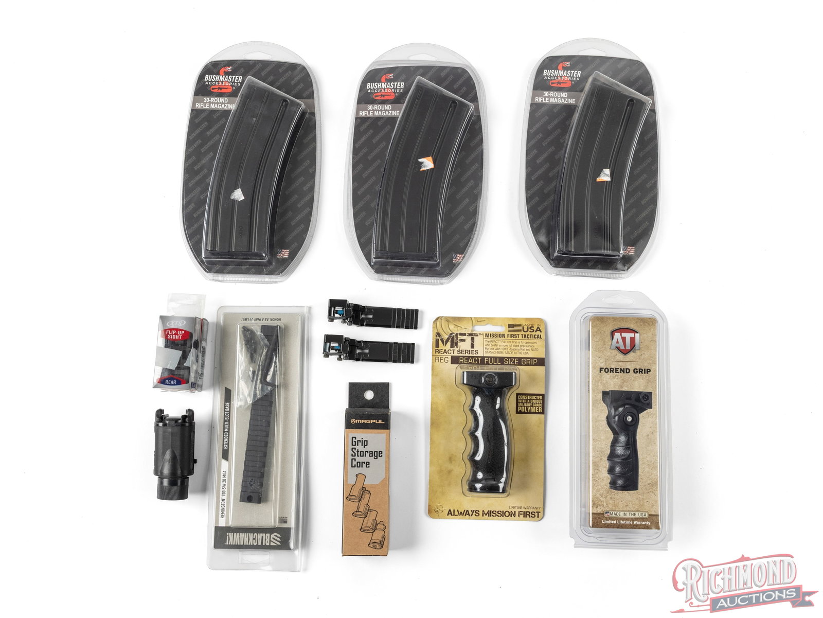Lot Of AR Magazines, Grips, And Sights: This lot contains various tactical and AR platform accessories. Included in this lot are 3 Bushmaster 30 round magazines still new in the package, an MFT vertical grip new in the package and an ATI
