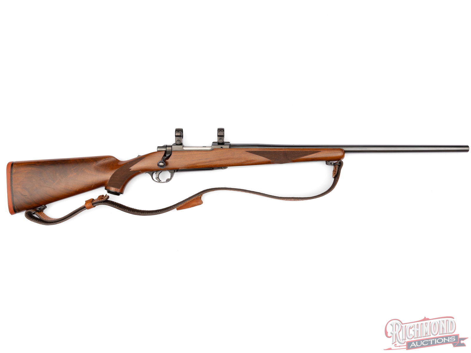 1974 Ruger Original Tang Safety M77 Bolt Action Rifle in .308 WIN Scope Ready: Manufactured by Sturm Ruger in 1971. This is the original tang safety model M77. Features a 24" sightless blued barrel, drilled and tapped for rear sight. Equipped with blued scope rings. Mauser style