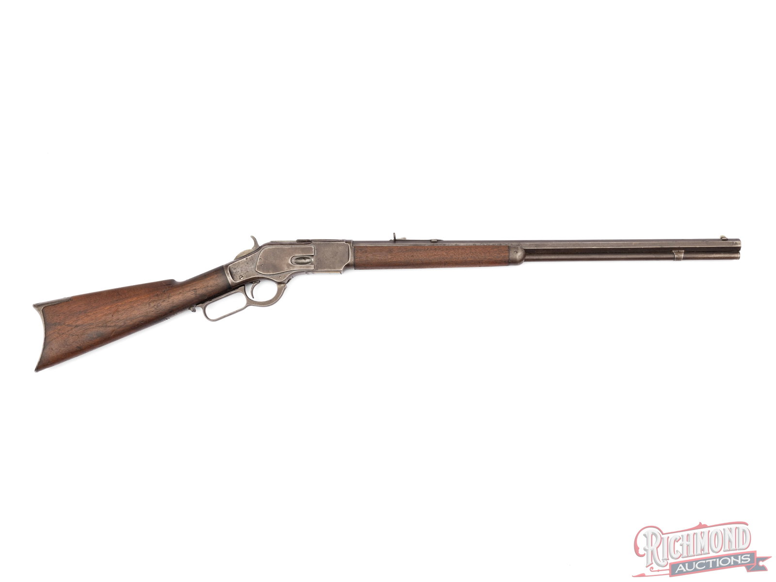Antique Winchester Model 1873 Lever Action Rifle In .32 WCF: Manufactured by Winchester in 1887. Features a 24" octagon barrel with rear semi-buckhorn adjustable notch and dovetailed front blade. Barrel is stamped with the King's Improvement patent and two