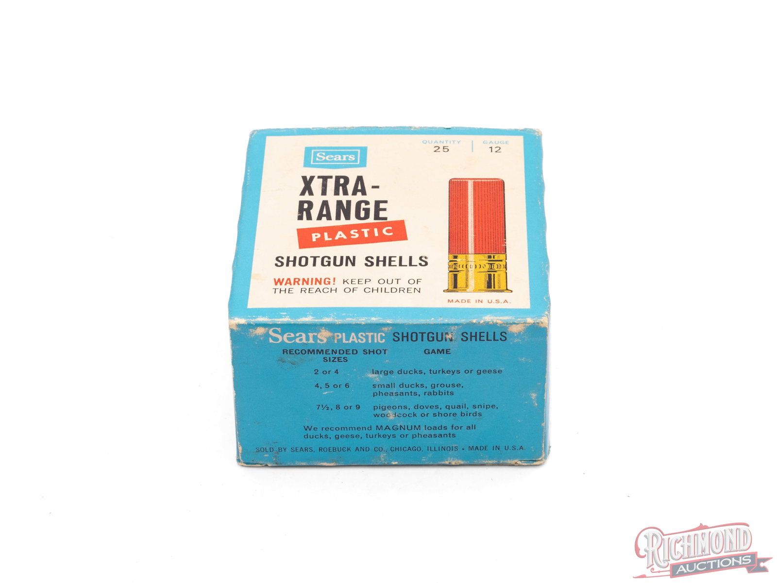 Full Box of Sears Xtra-Range 12 Gauge Plastic Shotgun Shells: This is a full box of 12 gauge Xtra-Range shotgun shells made by Sears and Roebuck Co. The box is relabeled on top with tape as 12 ga 1 1/8 oz 7 1/2 shot. Box has a bright blue color and one tab has
