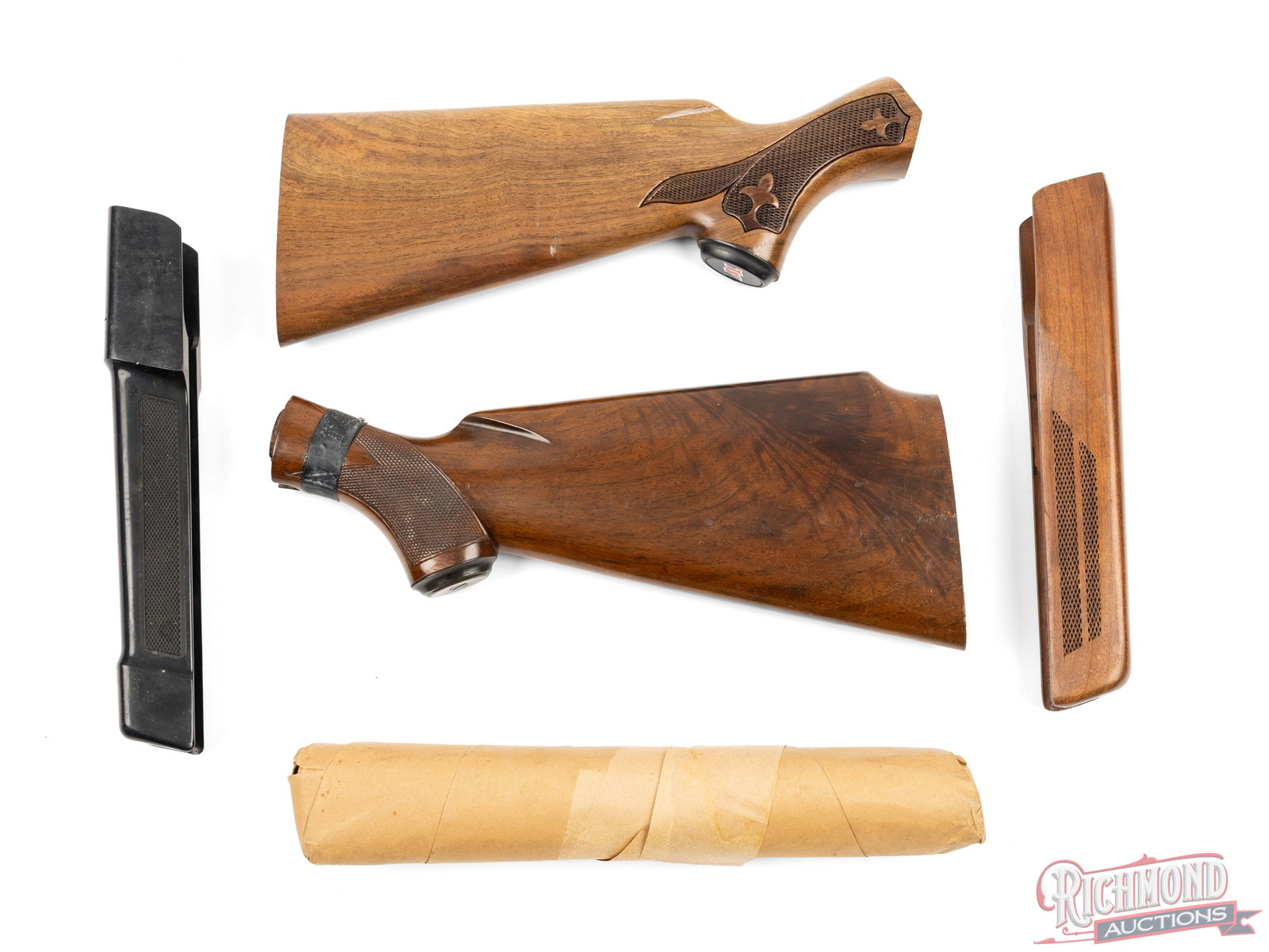 Lot of Assorted Winchester Stocks And Forends: This lot contains 2 stocks and 3 forends for Winchester shotguns. There is one stock in the box with a Fluer de Lis checkered grip and one forend sealed in paper wrapping. Condition VERY GOOD